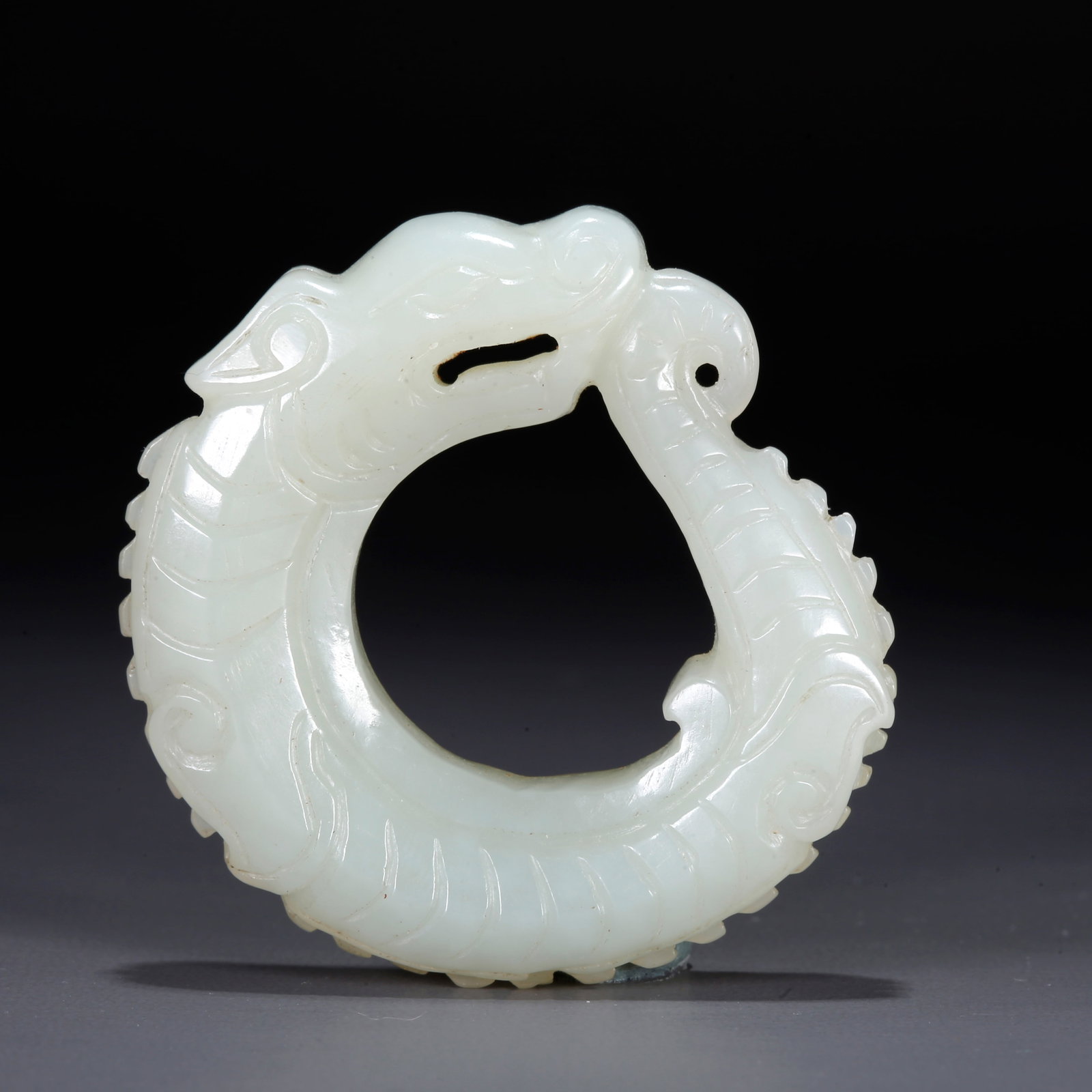 A CARVED HETIAN JADE PENDANT WITH DRAGON PATTERN: Carved Hetian Jade Pendant with Dragon Pattern