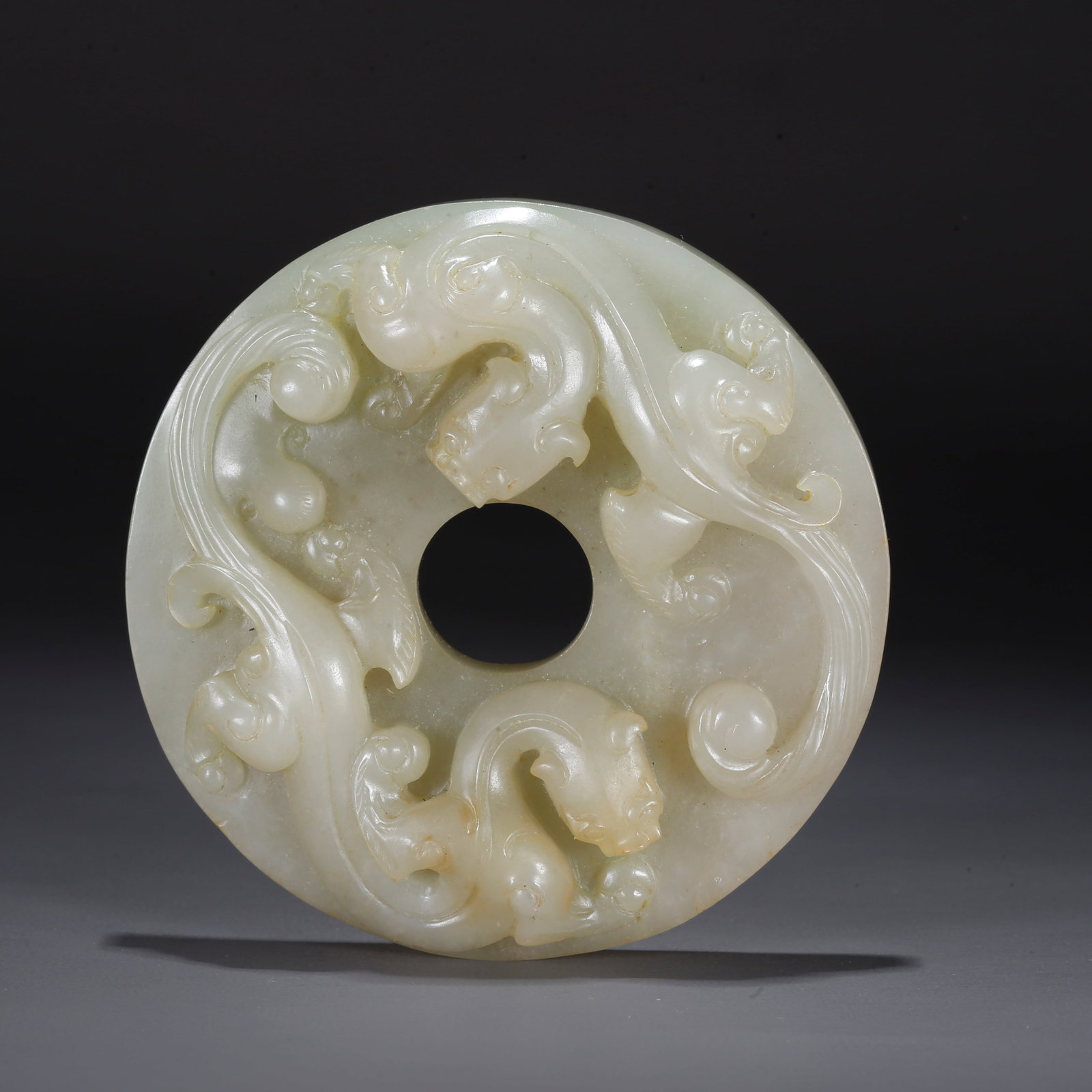 A CARVED HETIAN JADE BI DISC WITH DRAGON PATTERN (1 of 9)