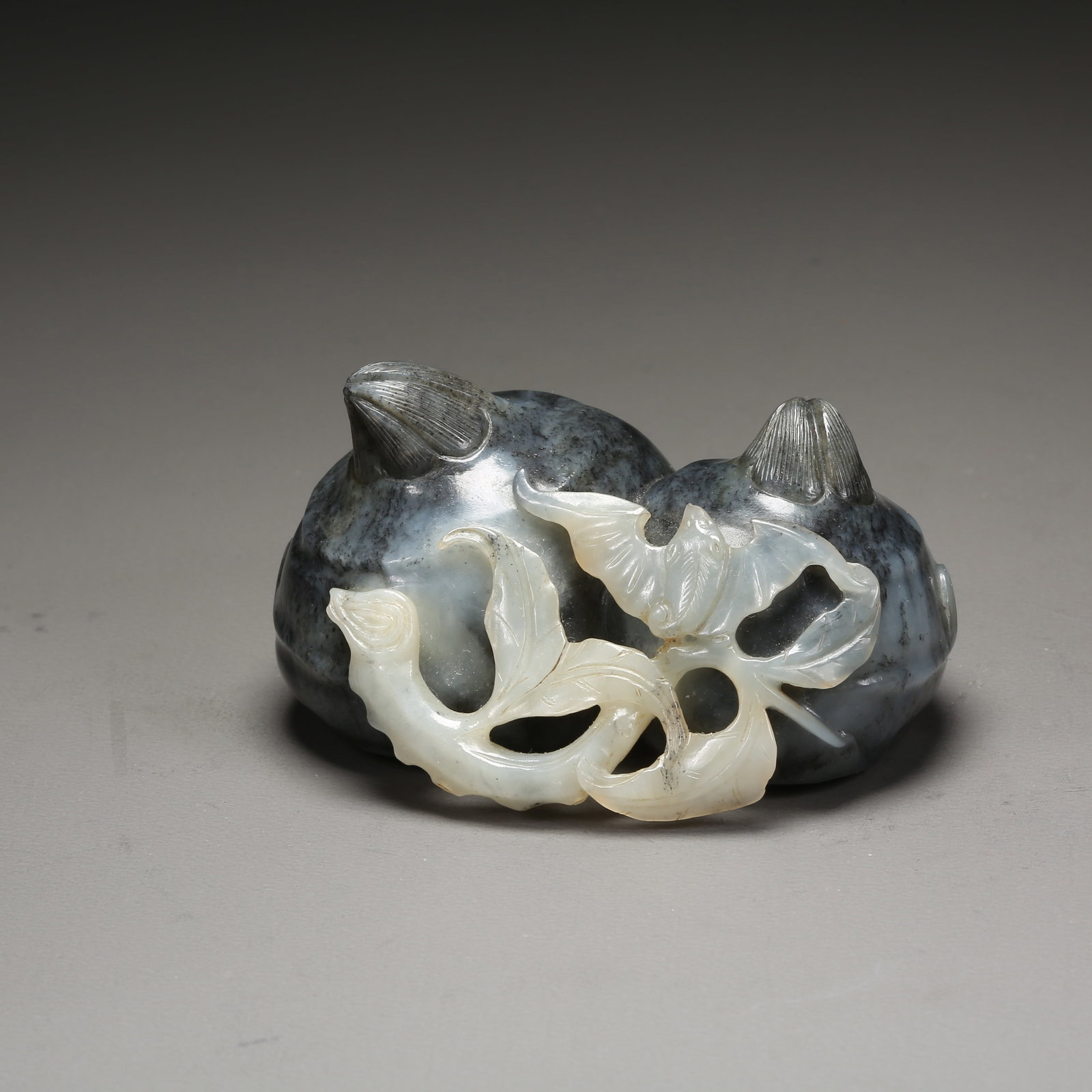 A HETIAN JADE INTRICATELY CARVED WATER CHESTNUT ORNAMENT: Hetian Jade Intricately Carved Water Chestnut Ornament