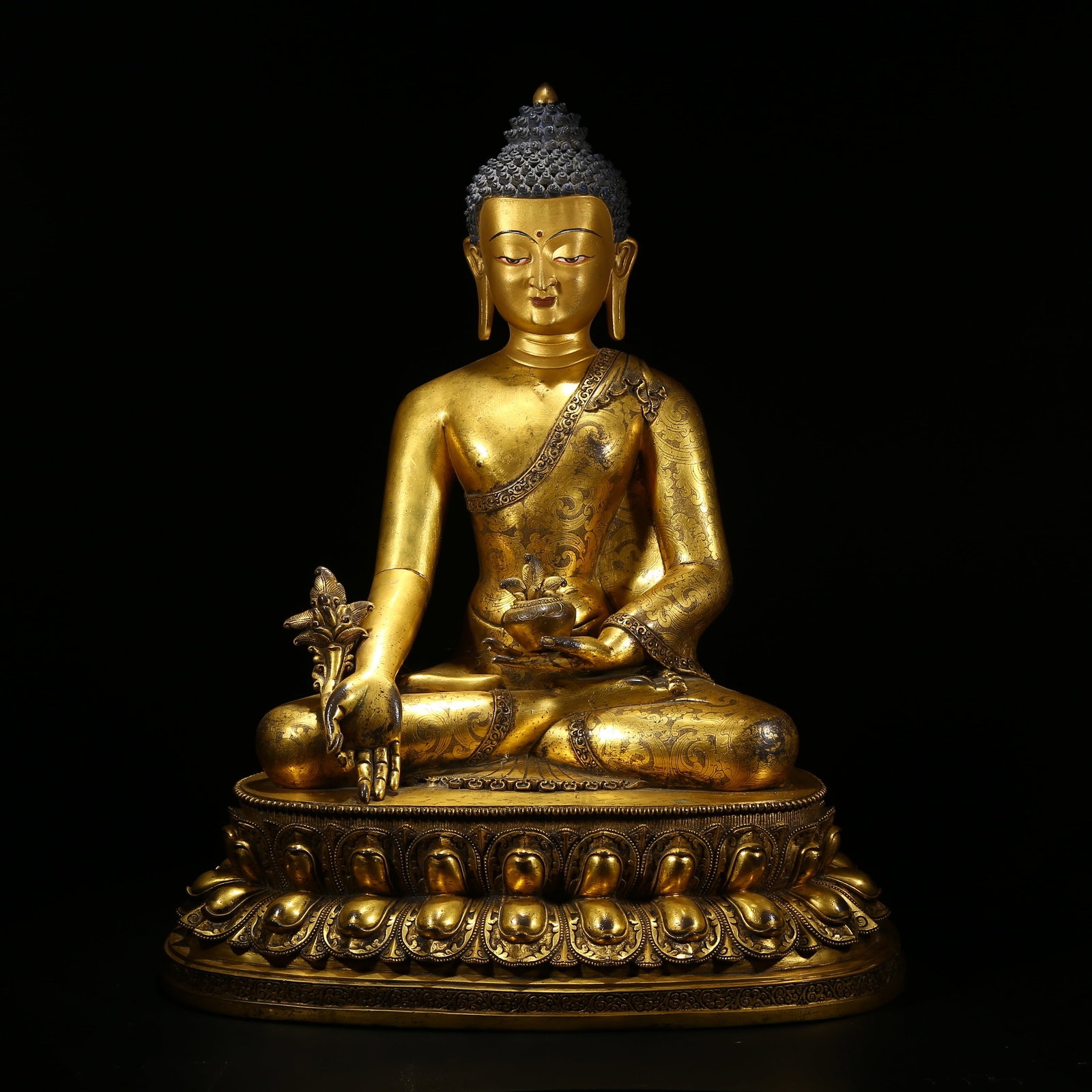 A GILDED BRONZE STATUE OF MEDICINE BUDDHA: Gilded bronze statue of Medicine Buddha