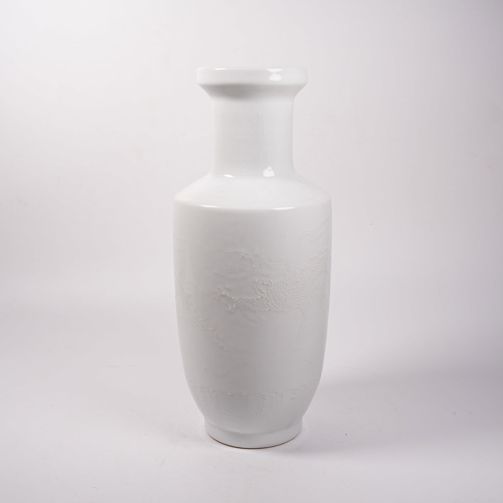 A WHITE PORCELAIN GUANYIN VASE WITH SUBTLY CARVED DRAGON PATTERN: White Porcelain Guanyin Vase with Subtly Carved Dragon Pattern