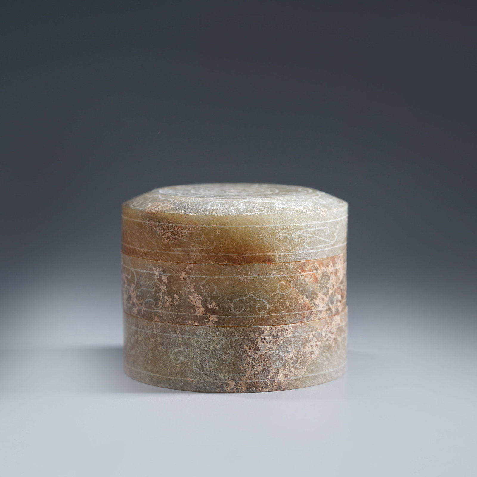 A ANCIENT JADE SCROLL-CLOUD MOTIF ROUND LIDDED BOXES (TRIPLE SET): Ancient jade scroll-cloud motif round lidded boxes (triple set)