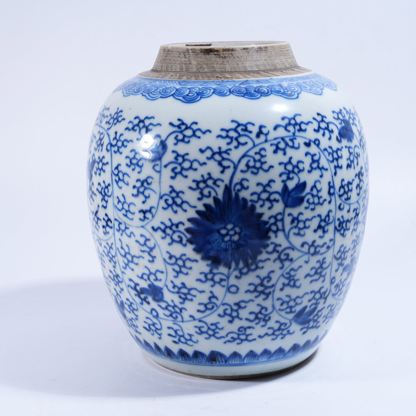 A BLUE AND WHITE JAR WITH INTERLOCKING FLORAL PATTERN: Blue and White Jar with Interlocking Floral Pattern