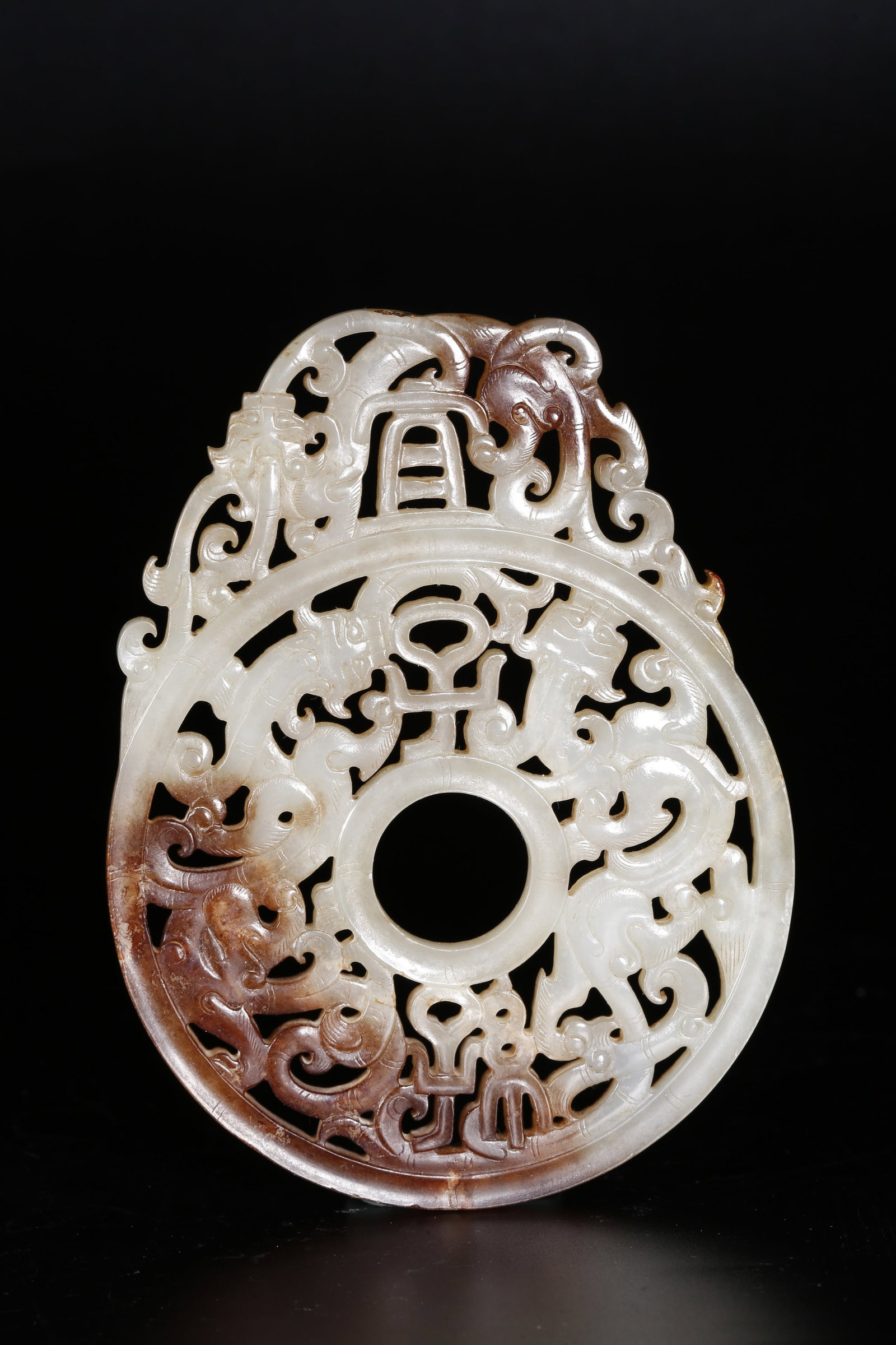 A OUTLINED DRAGON-PATTERNED BI DISC CARVED FROM HETIAN JADE: Outlined Dragon-patterned Bi Disc Carved from Hetian Jade