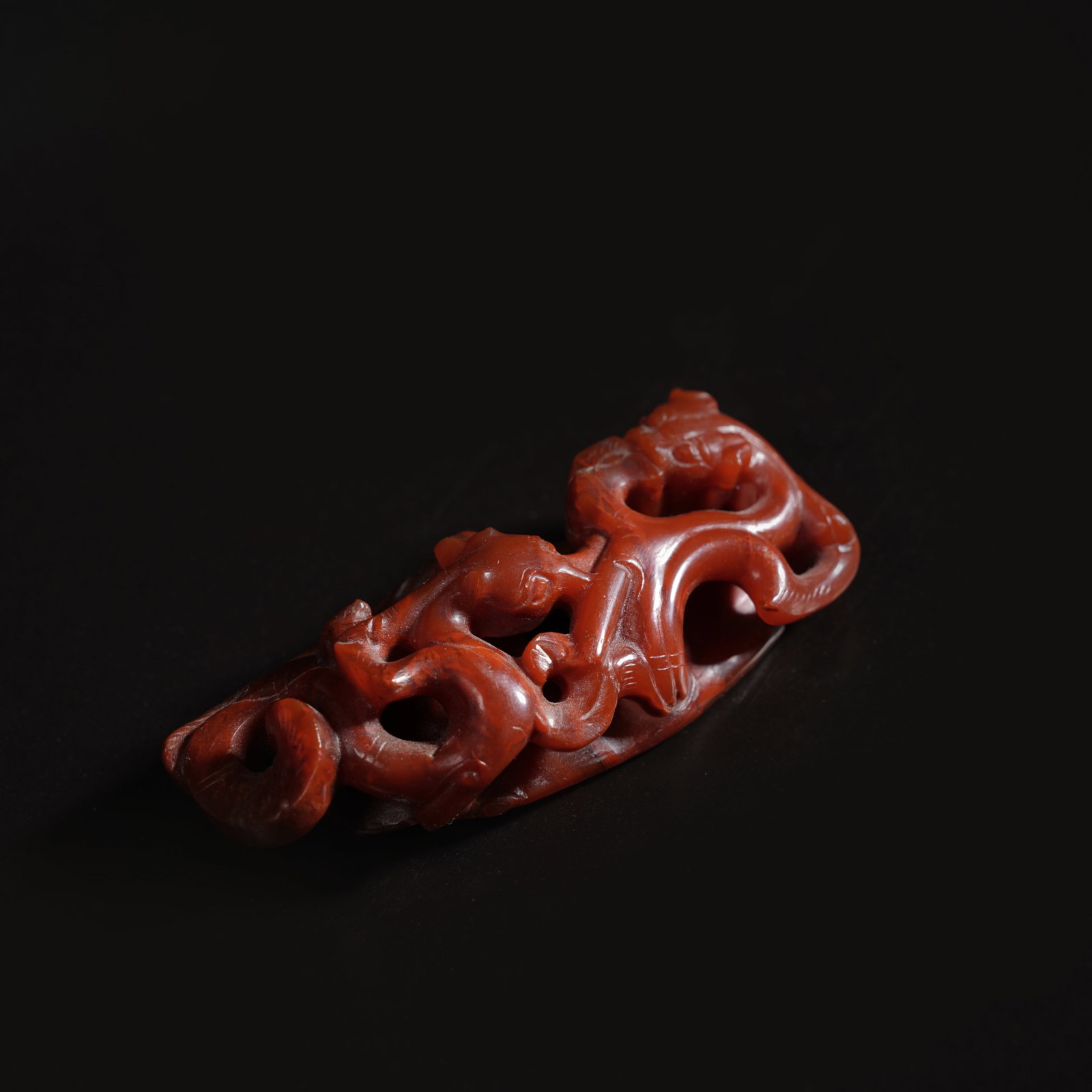 A WARRING STATES RED AGATE OPENWORK CHI-DRAGON "CHICKEN-HEART" PENDANT (1 of 5)