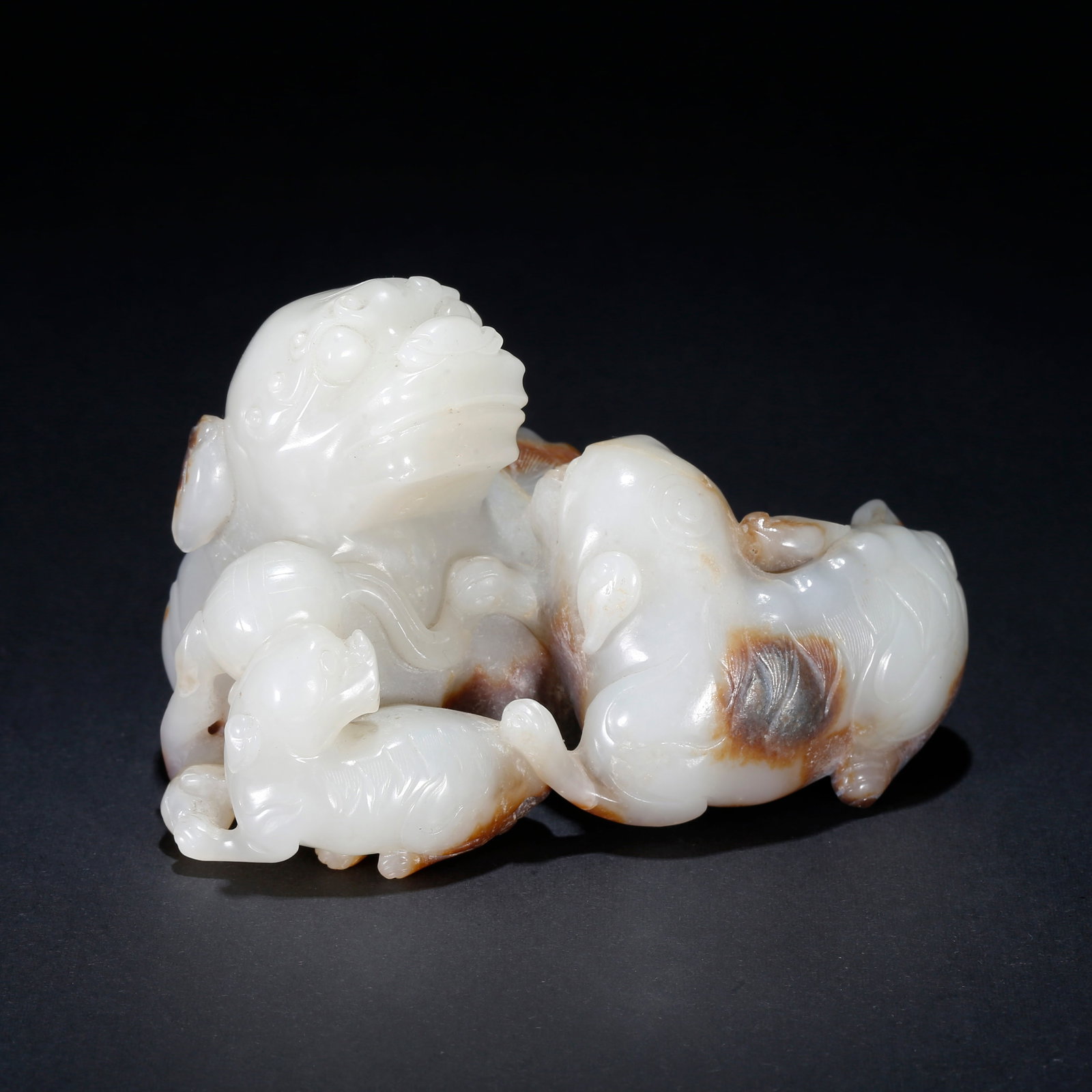 A HETIAN JADE CARVED LION ROLLING EMBROIDERED BALL ORNAMENT: Hetian Jade Carved Lion Rolling Embroidered Ball Ornament
