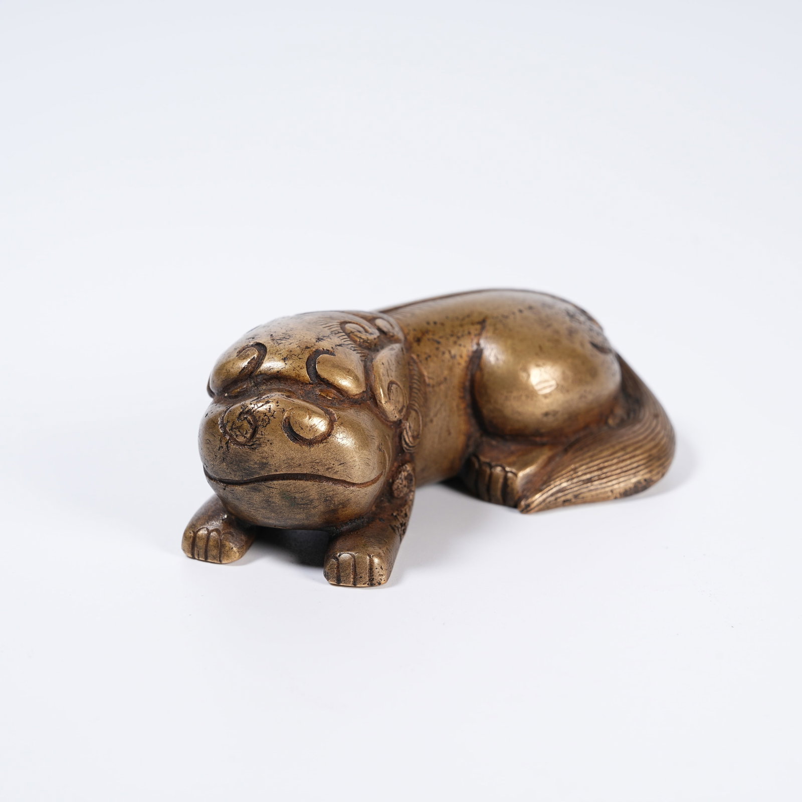 A BRONZE RECUMBENT BEAST PAPERWEIGHT (1 of 8)