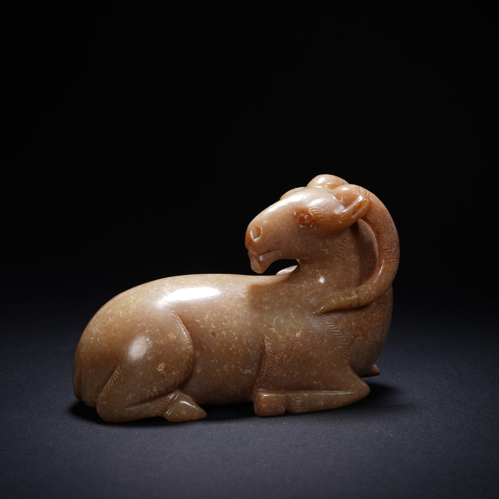 A ANCIENT JADE RECUMBENT RAM ORNAMENT: Ancient jade recumbent ram ornament