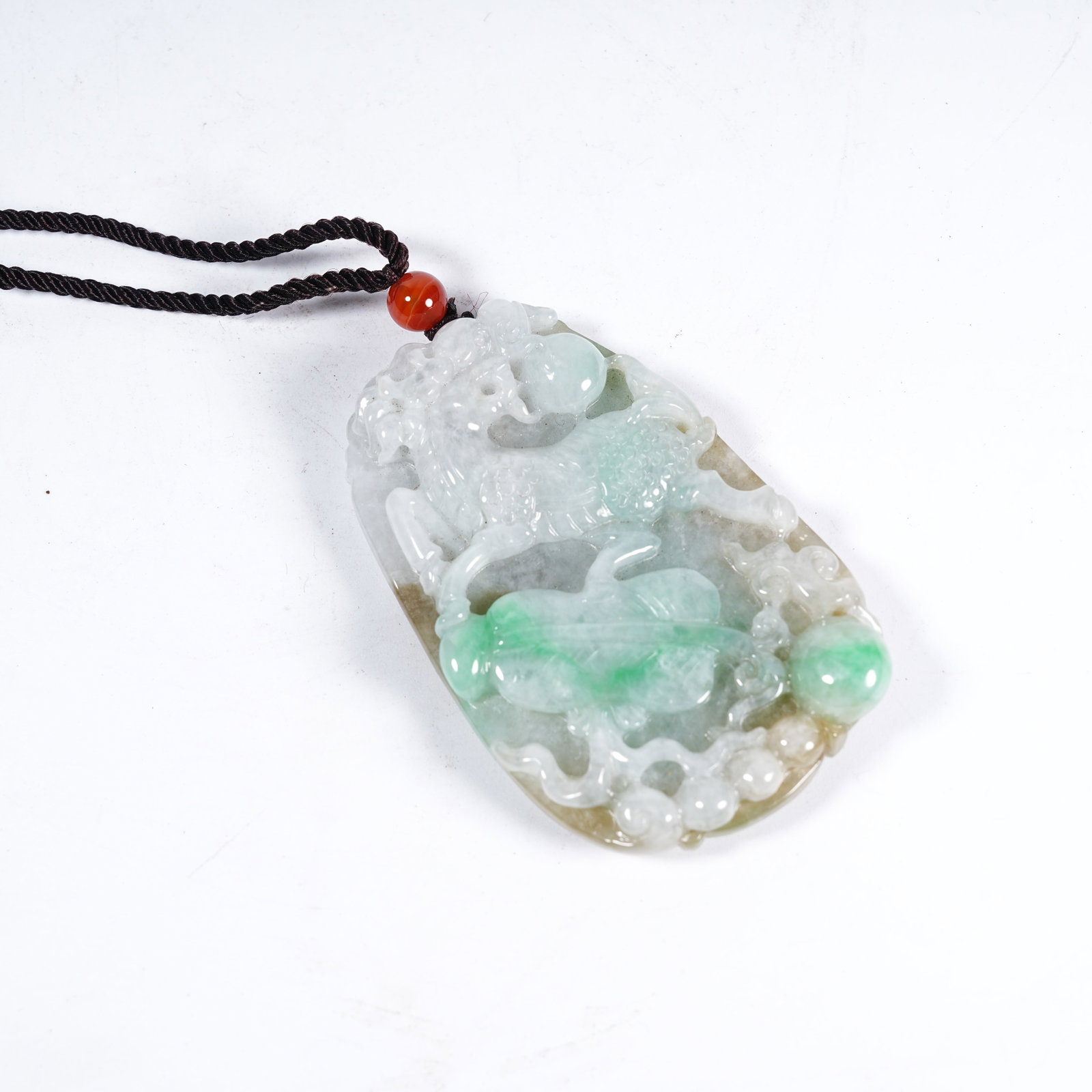 A JADEITE KYLIN AUSPICIOUS PATTERN PENDANT: Jadeite Kylin Auspicious Pattern Pendant
