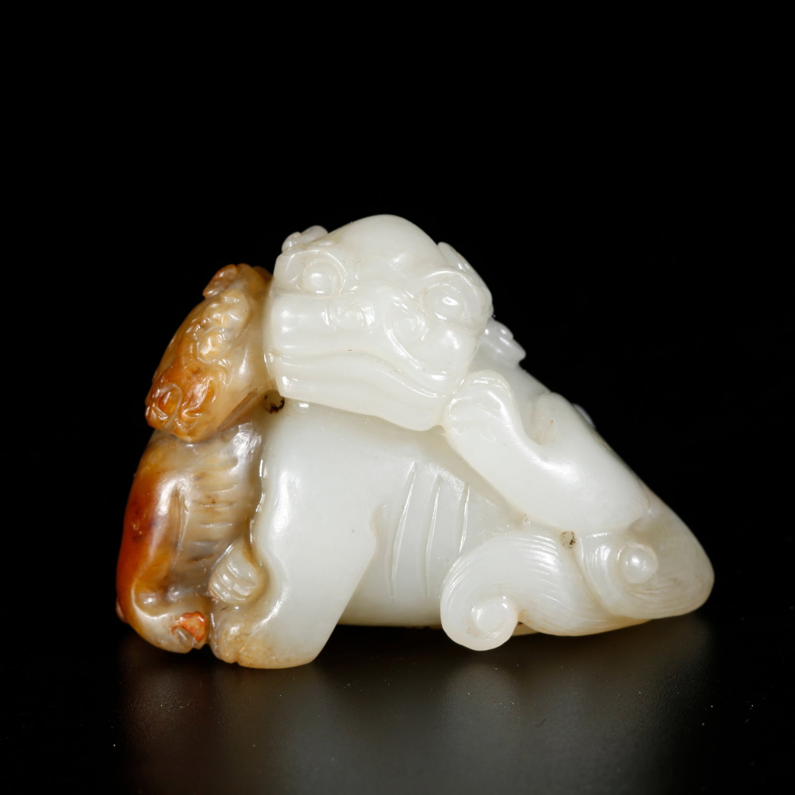 A HETIAN JADE LION-SHAPED ORNAMENT (1 of 9)