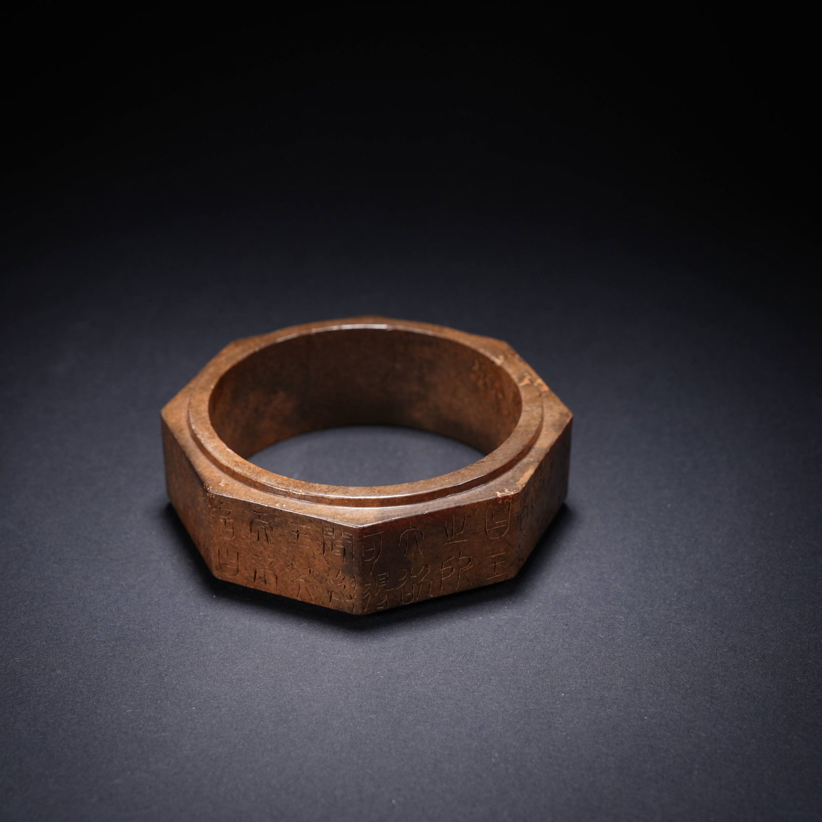 A ANCIENT JADE INSCRIBED OCTAGONAL BRACELET: Ancient jade inscribed octagonal bracelet
