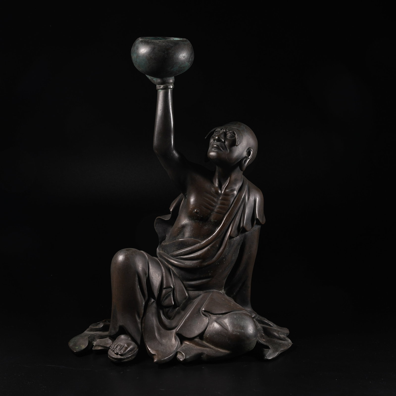 A BRONZE ORNAMENT OF ARHAT SUPPORTING CENSER: Bronze Ornament of Arhat Supporting Censer