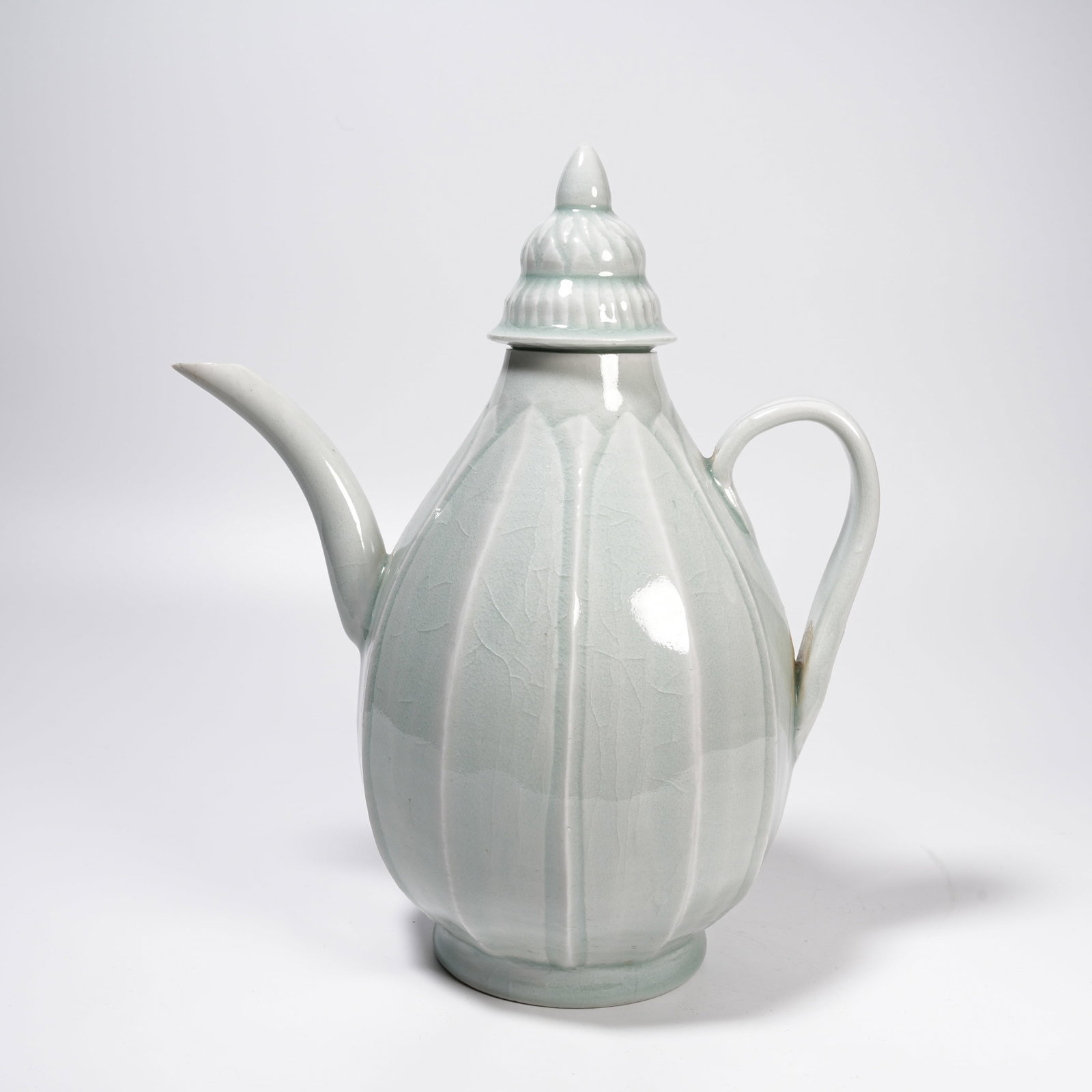 A SHADOW CELADON GLAZE MELON-RIDGED EWER: Shadow Celadon Glaze Melon-ridged Ewer