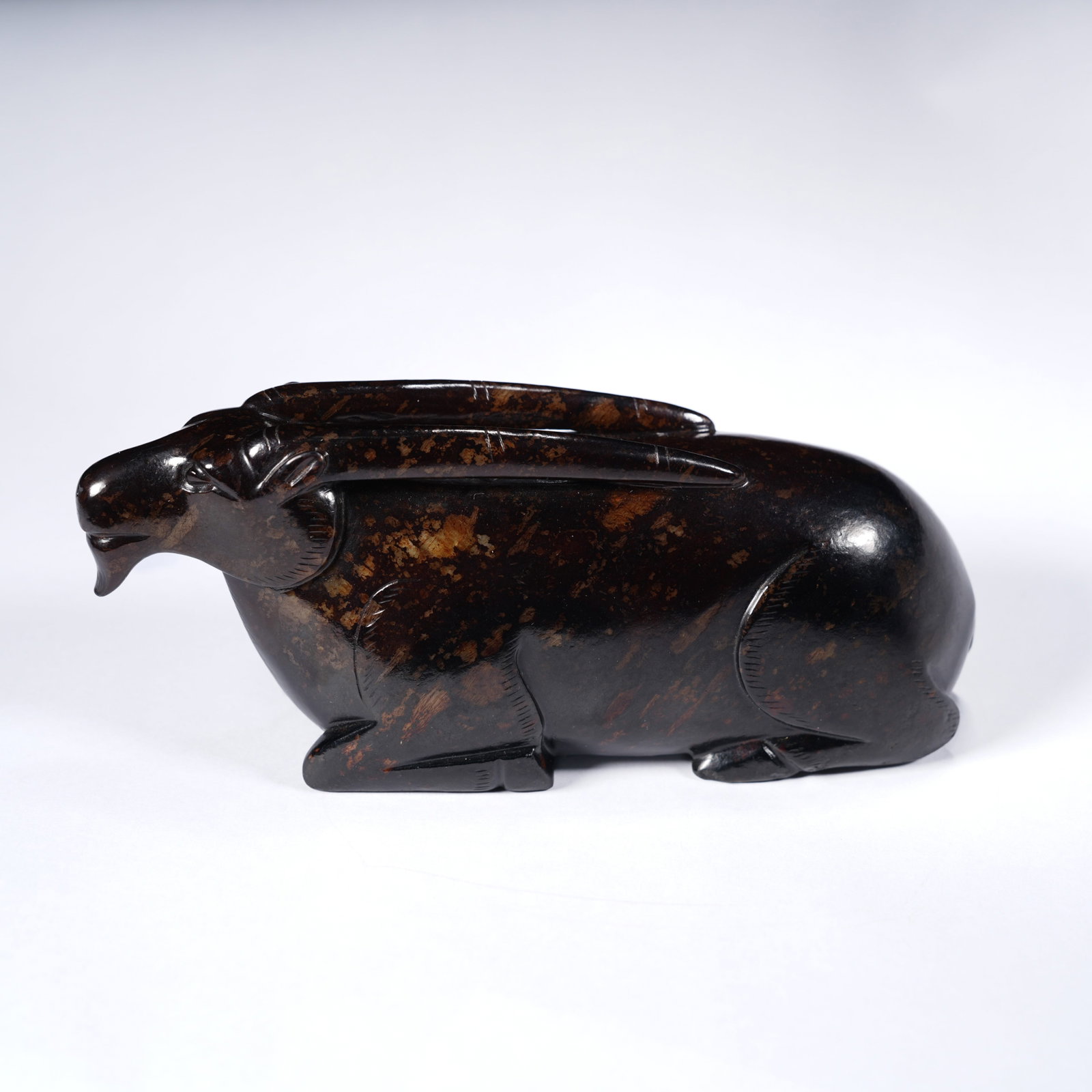 A ANCIENT JADE RECUMBENT RAM ORNAMENT: Ancient jade recumbent ram ornament