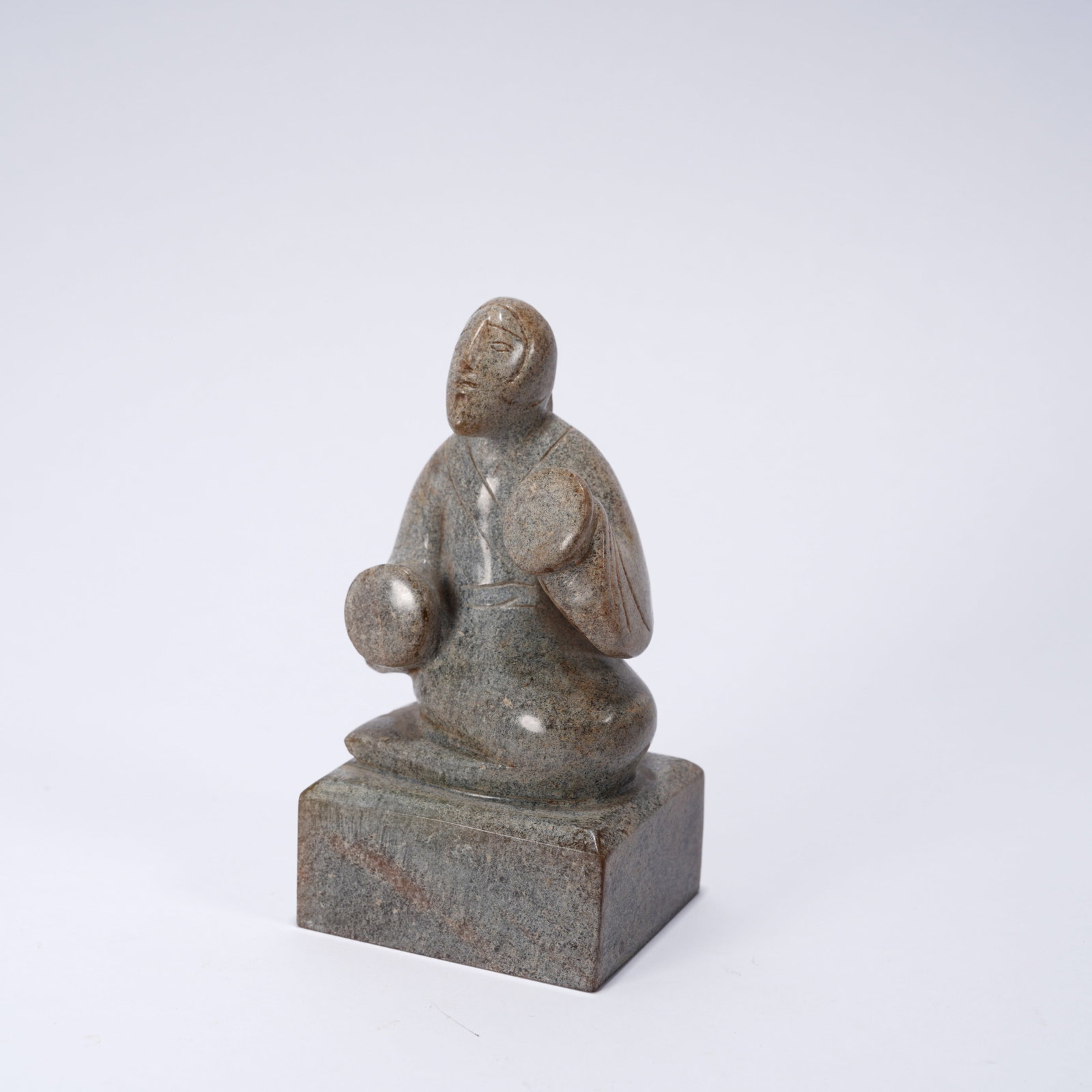 A ANCIENT JADE SEAL WITH PANPIPE MUSICIAN FIGURE KNOB: Ancient jade seal with panpipe musician figure knob