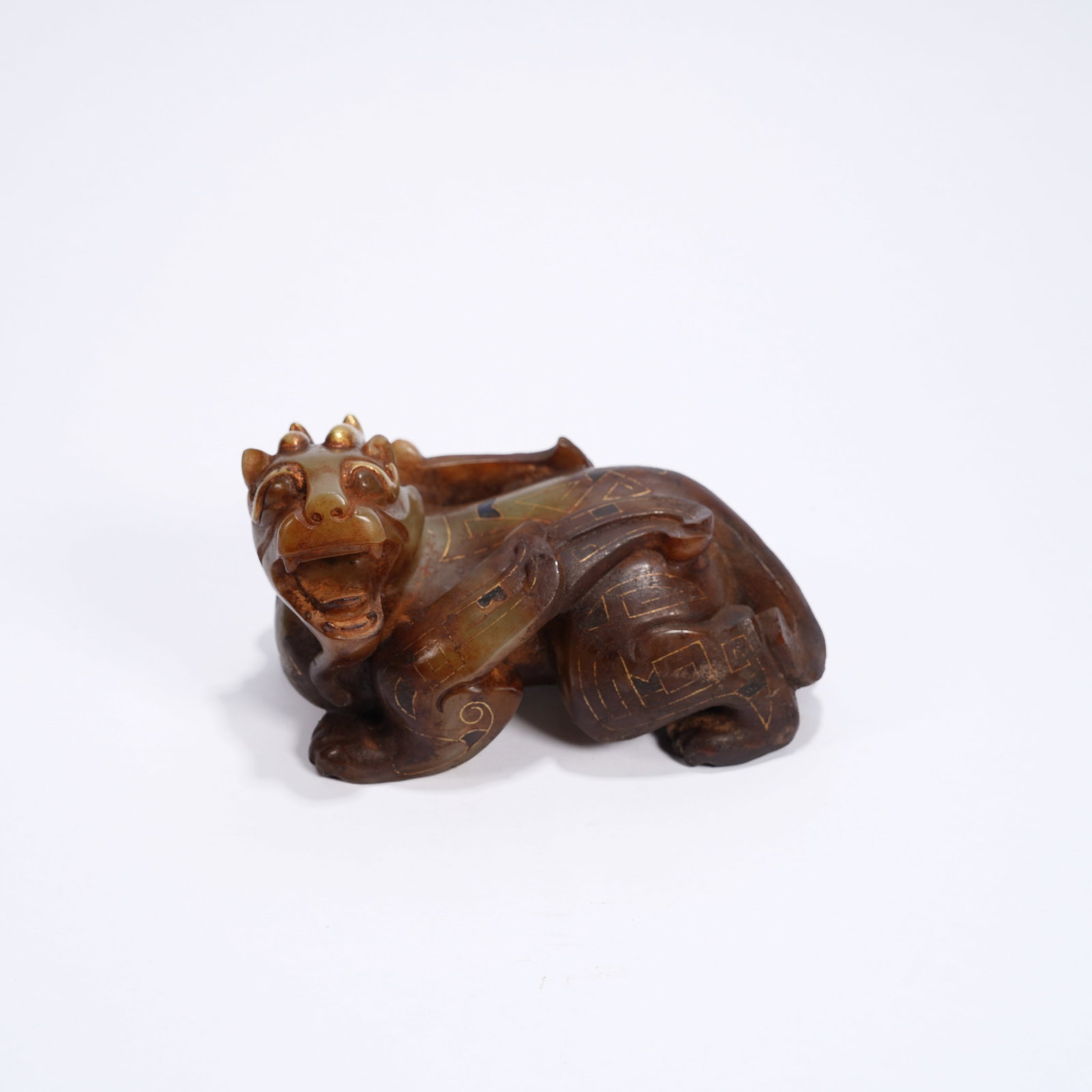 A ANCIENT JADE GILT-INLAID AUSPICIOUS BEAST ORNAMENT: Ancient jade gilt-inlaid auspicious beast ornament