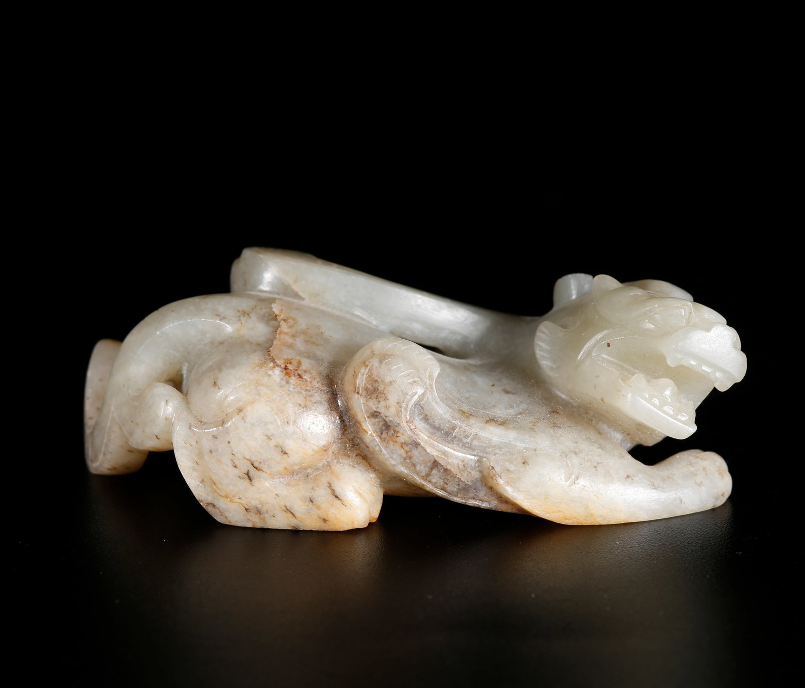 A BEAST-SHAPED ORNAMENT CARVED FROM HETIAN JADE: Beast-shaped Ornament Carved from Hetian Jade