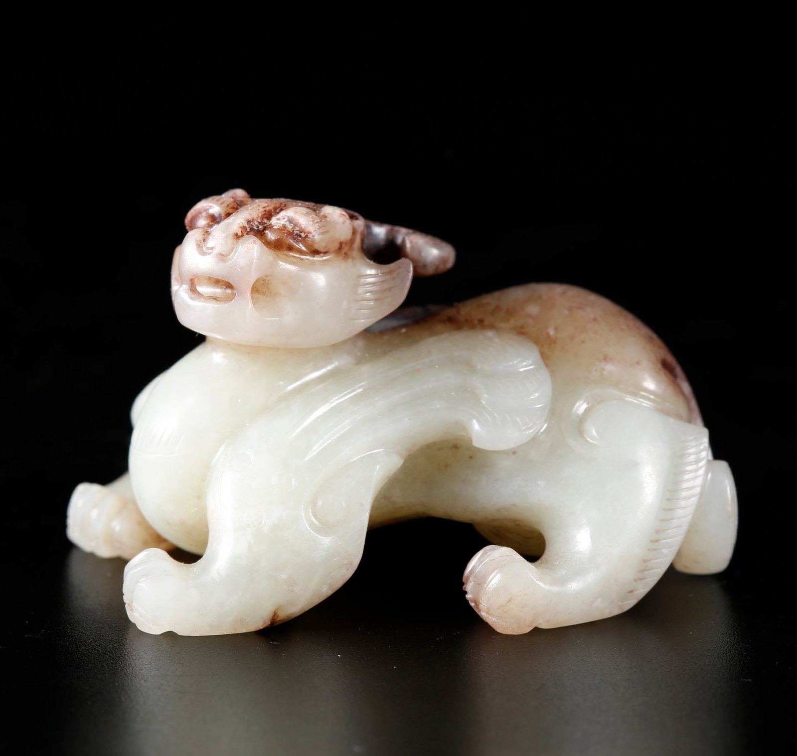 A BEAST-SHAPED ORNAMENT CARVED FROM HETIAN JADE (1 of 9)