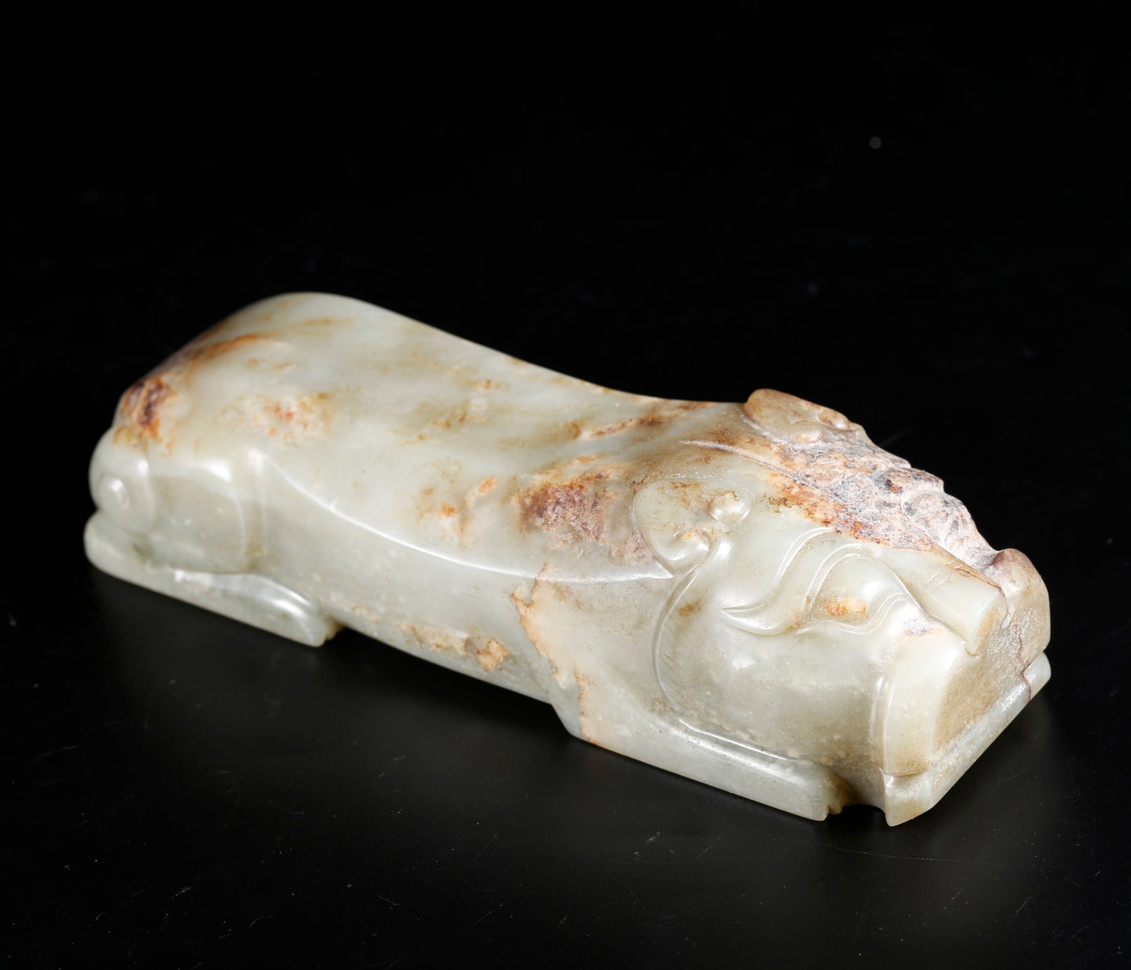 A BEAST-SHAPED PAPERWEIGHT CARVED FROM HETIAN JADE (1 of 10)