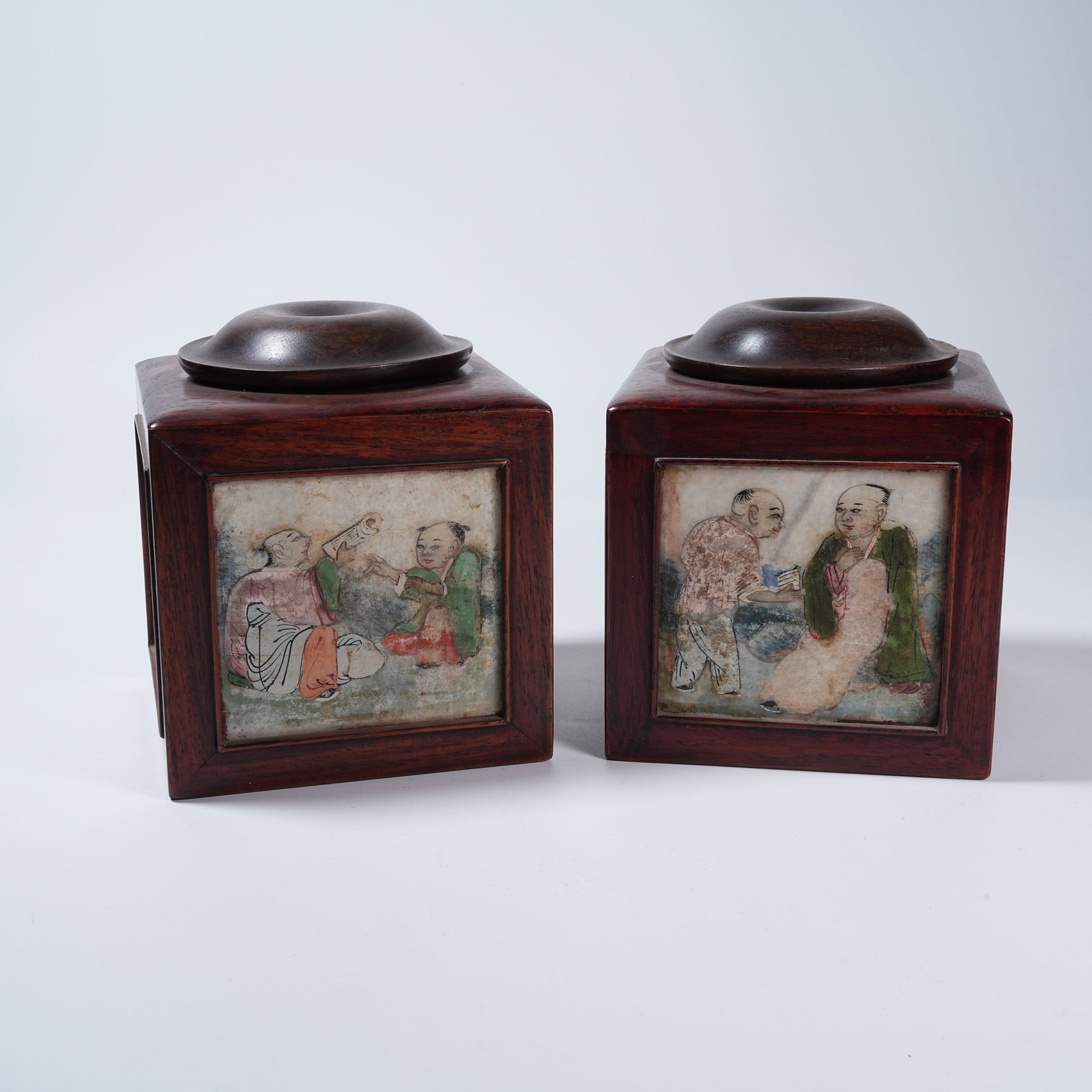 A SET OF MAHOGANY GO JARS INLAID WITH FAMILLE ROSE PORCELAIN PANEL FIGURE STORY PATTERN: Set of Mahogany Go Jars Inlaid with Famille Rose Porcelain Panel Figure Story Pattern