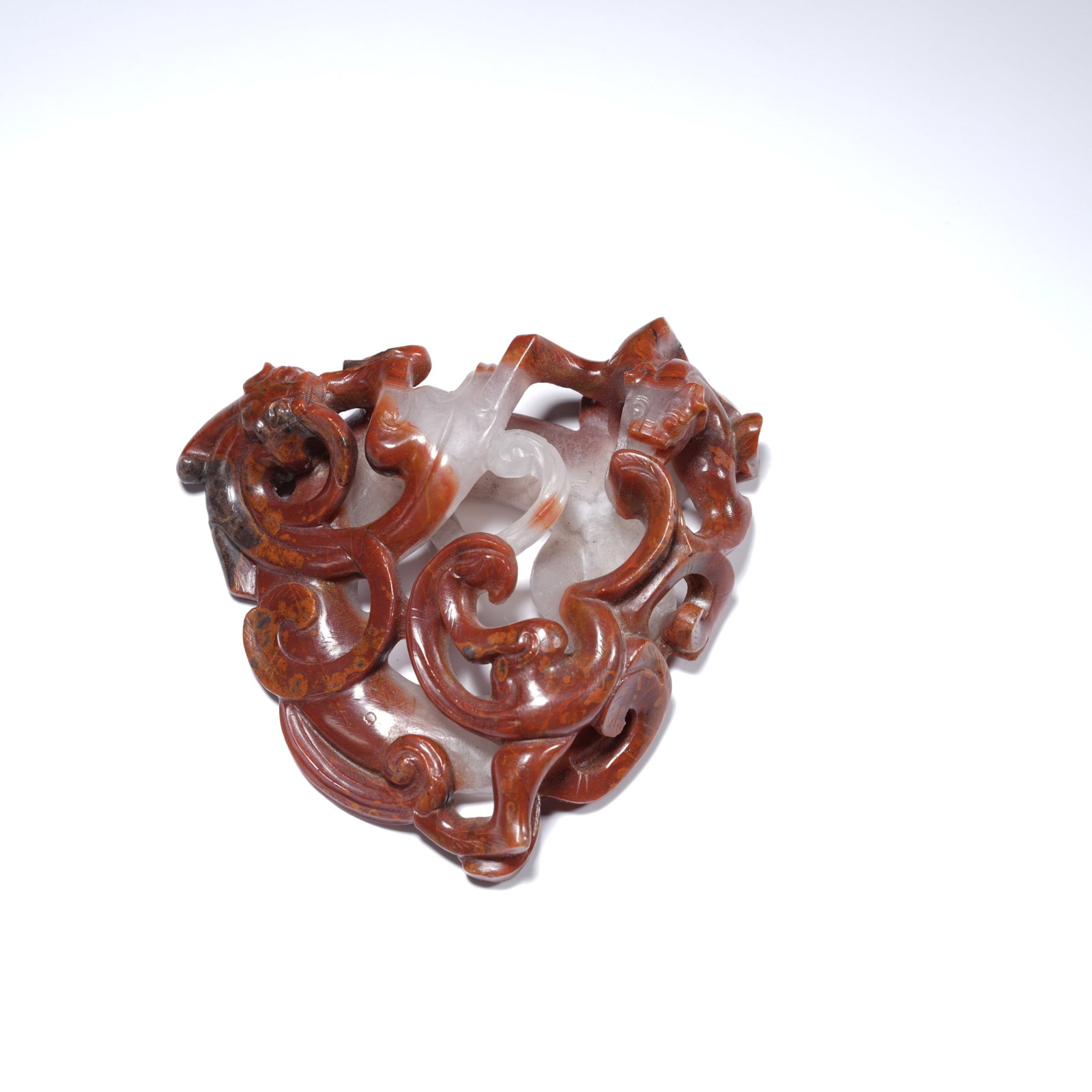 A WARRING STATES RED AGATE OPENWORK DOUBLE-DRAGON CUP-WALL FRAGMENT: Warring States red agate openwork double-dragon cup-wall fragment