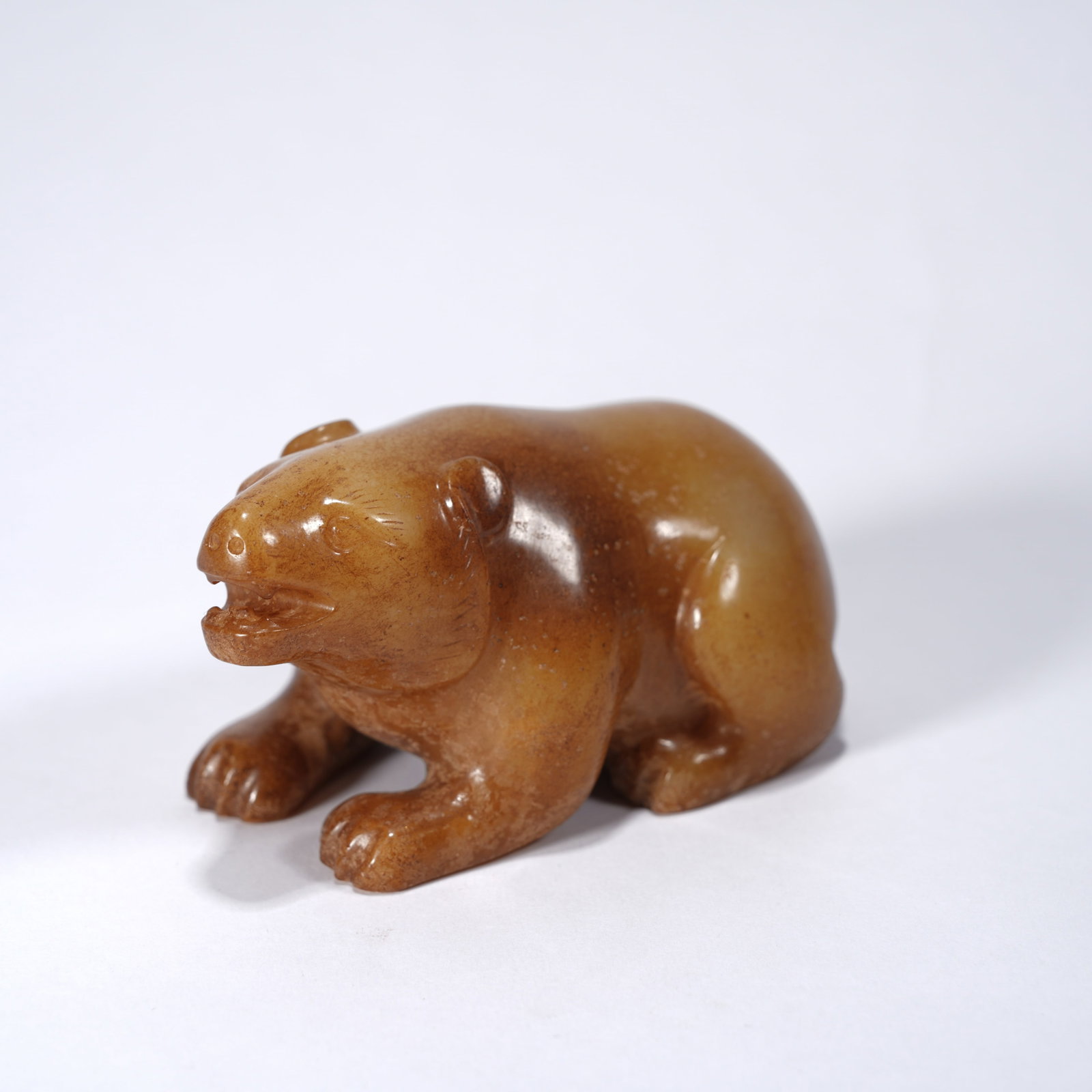 A ANCIENT JADE RECUMBENT BEAR ORNAMENT: Ancient jade recumbent bear ornament