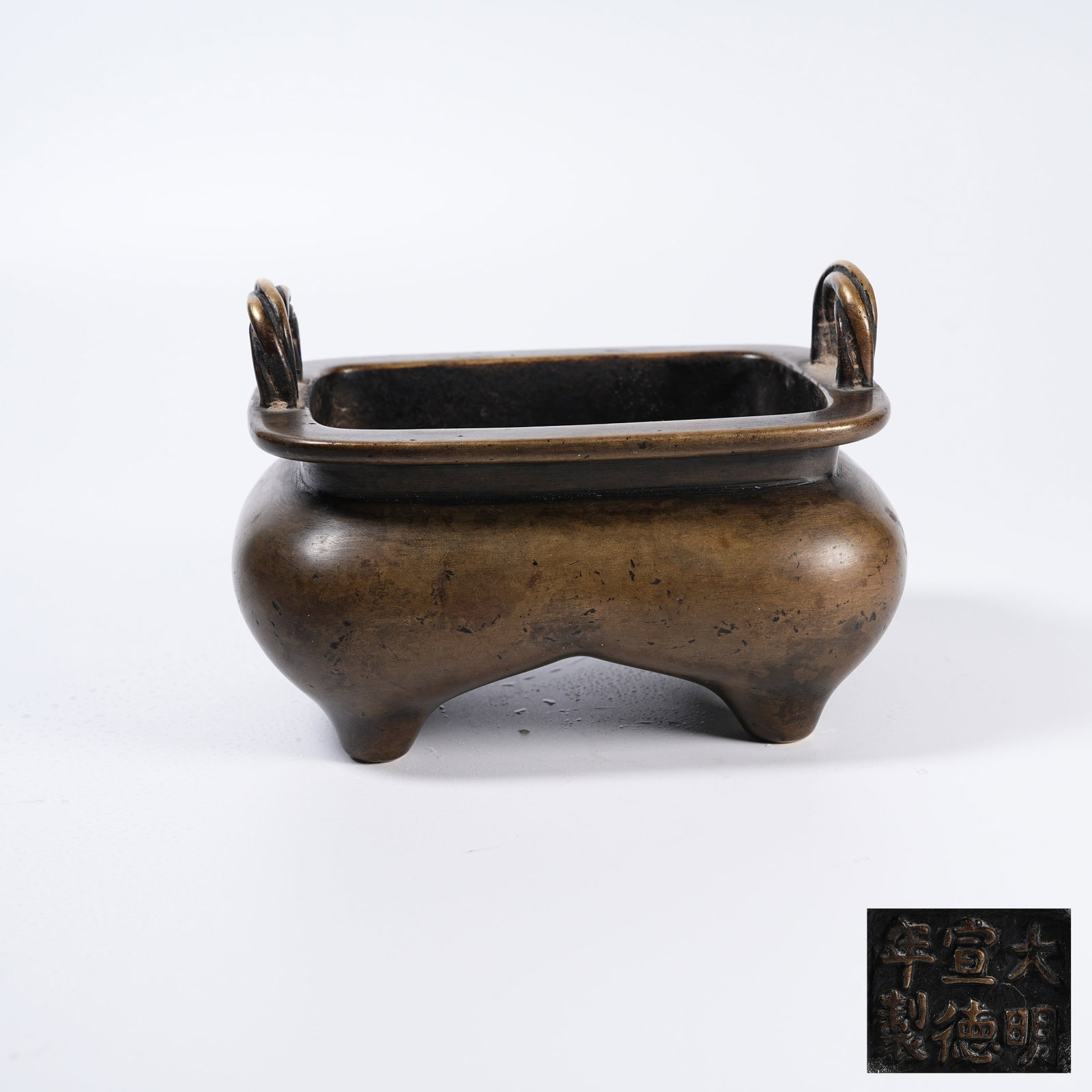 A BRONZE TWISTED-WIRE EARED CENSER: Bronze Twisted-wire Eared Censer