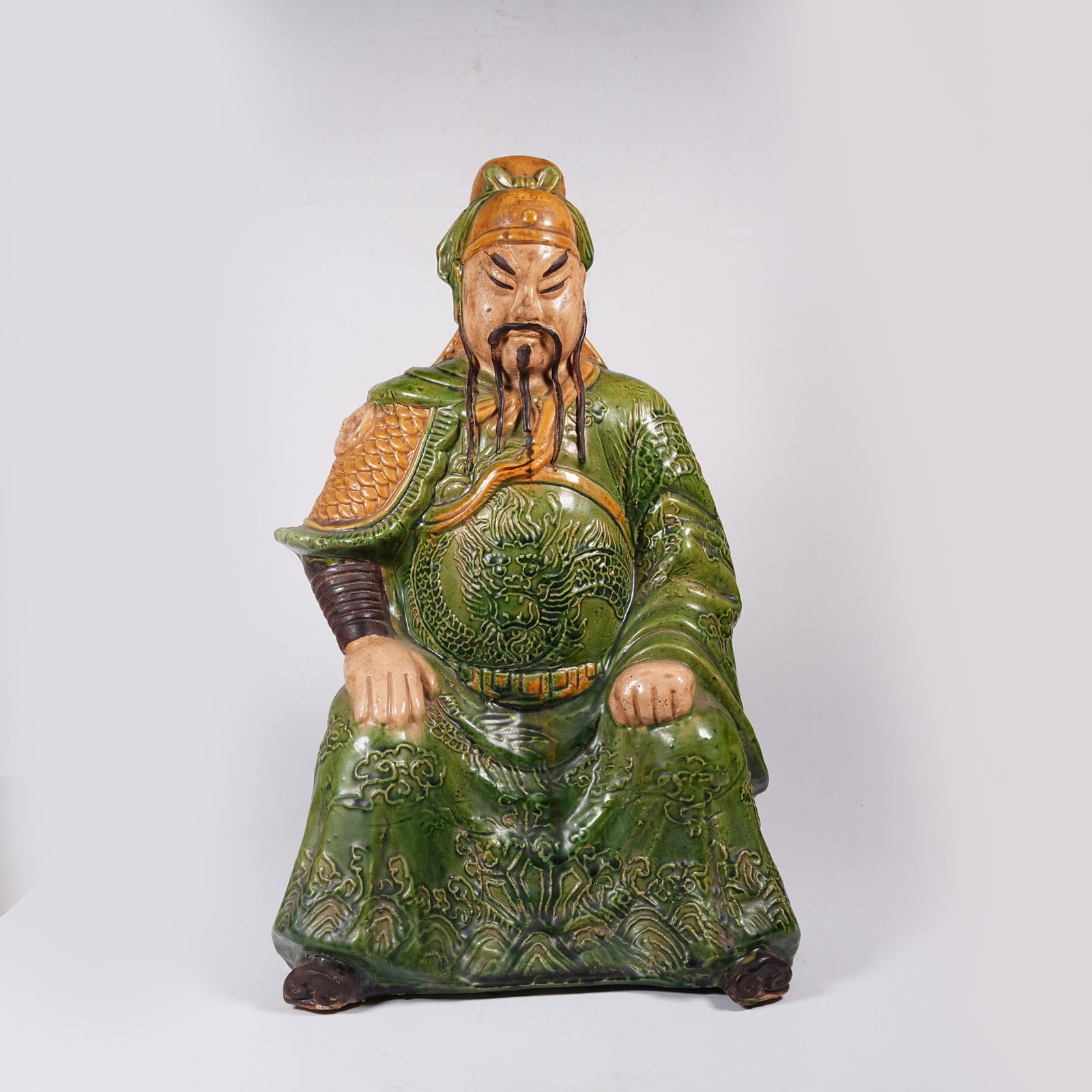 A PLAIN TRICOLOR SEATED GUAN GONG: Plain Tricolor Seated Guan Gong