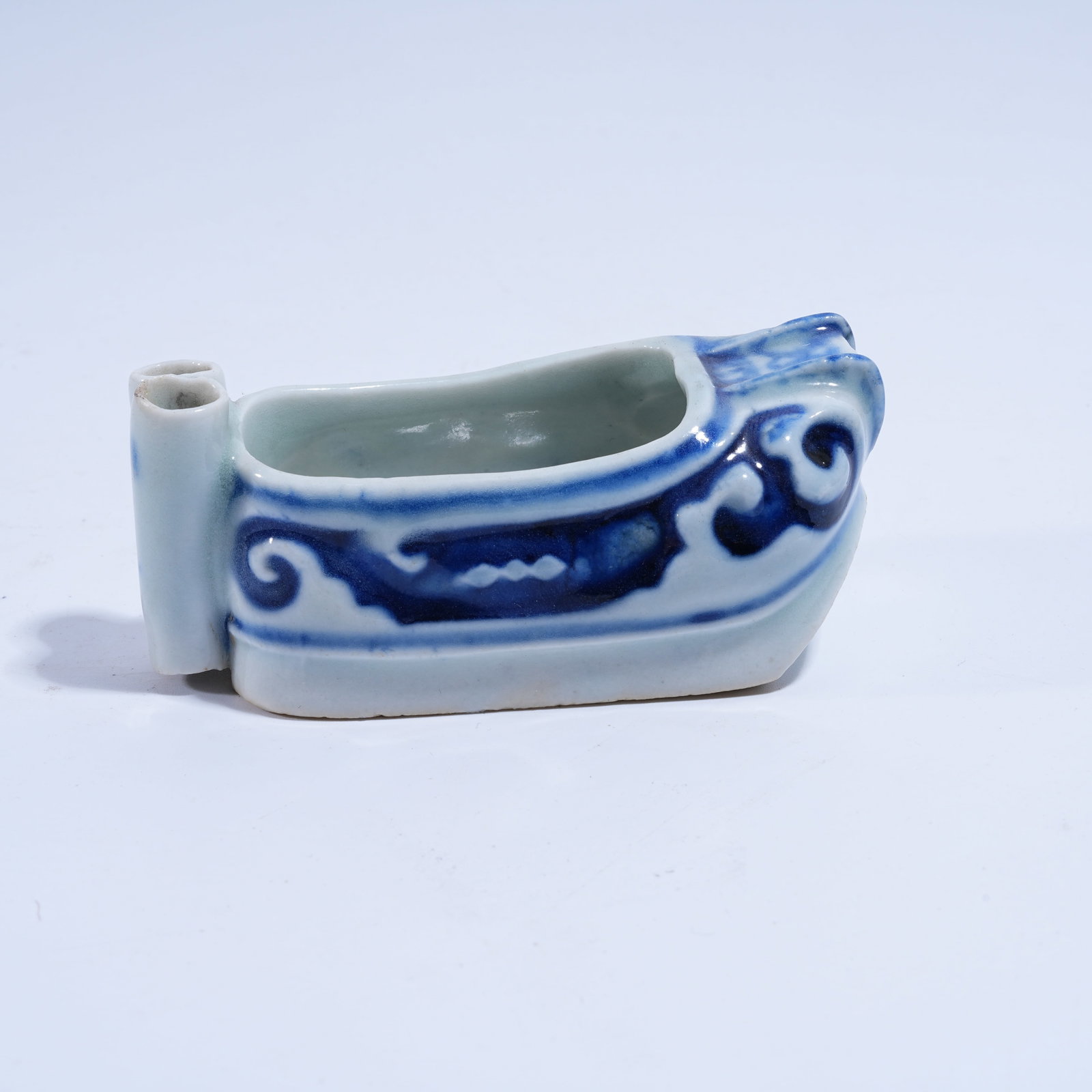A BLUE AND WHITE EMBROIDERED SHOE-SHAPED WATER POT: Blue and White Embroidered Shoe-shaped Water Pot