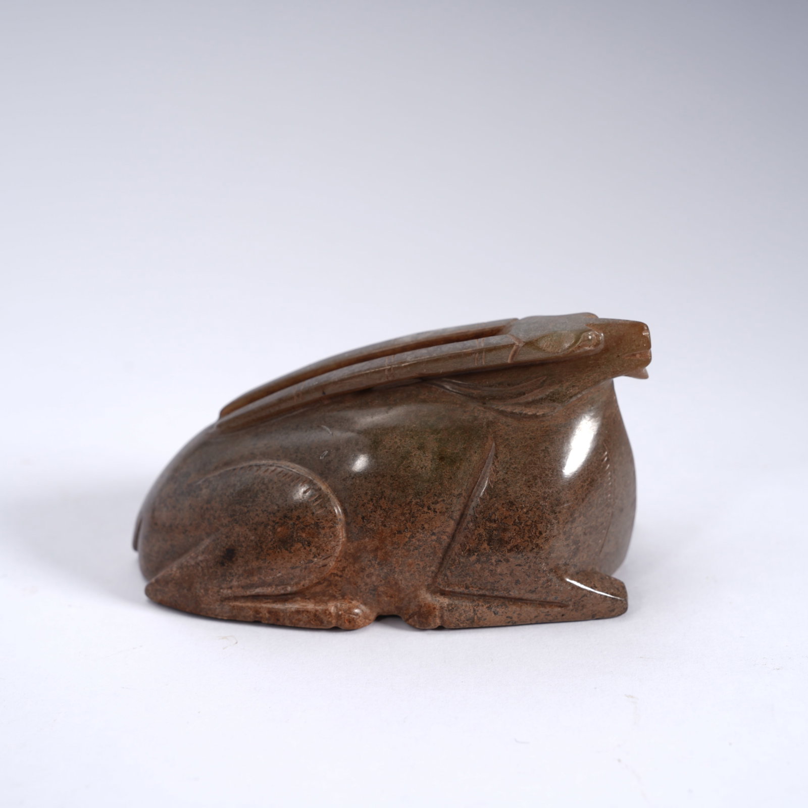 A ANCIENT JADE RECUMBENT RAM ORNAMENT: Ancient jade recumbent ram ornament
