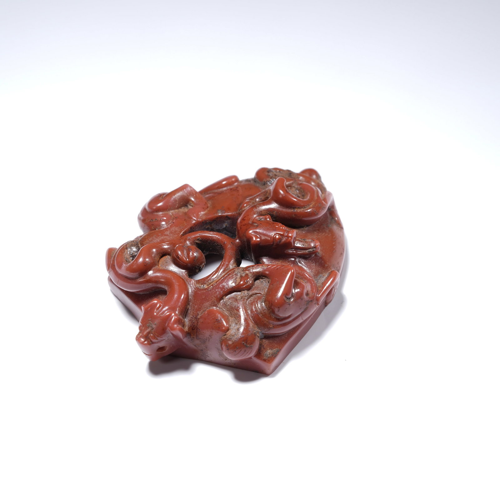 A WARRING STATES RED AGATE OPENWORK DOUBLE-DRAGON "CHICKEN-HEART" PENDANT (1 of 5)