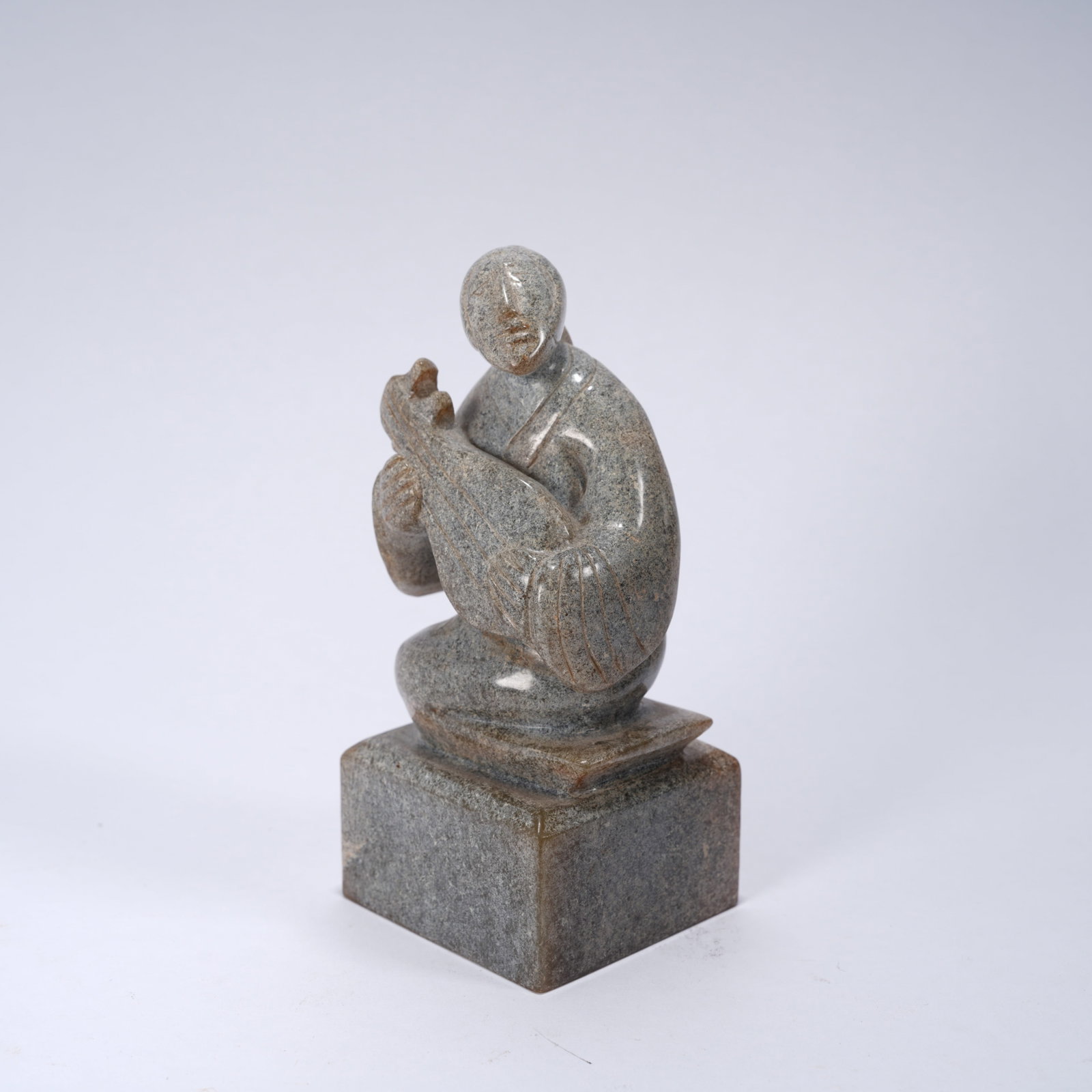 A ANCIENT JADE SEAL WITH PIPA (LUTE) MUSICIAN FIGURE KNOB: Ancient jade seal with pipa (lute) musician figure knob