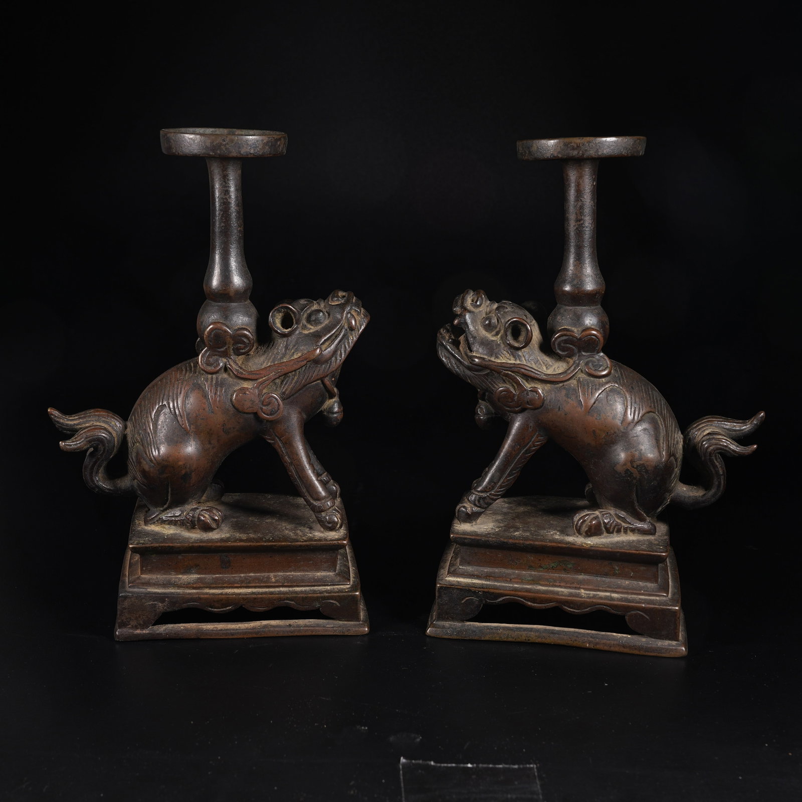A SET OF BRONZE AUSPICIOUS BEAST SUPPORTED OIL LAMPS: Set of Bronze Auspicious Beast Supported Oil Lamps