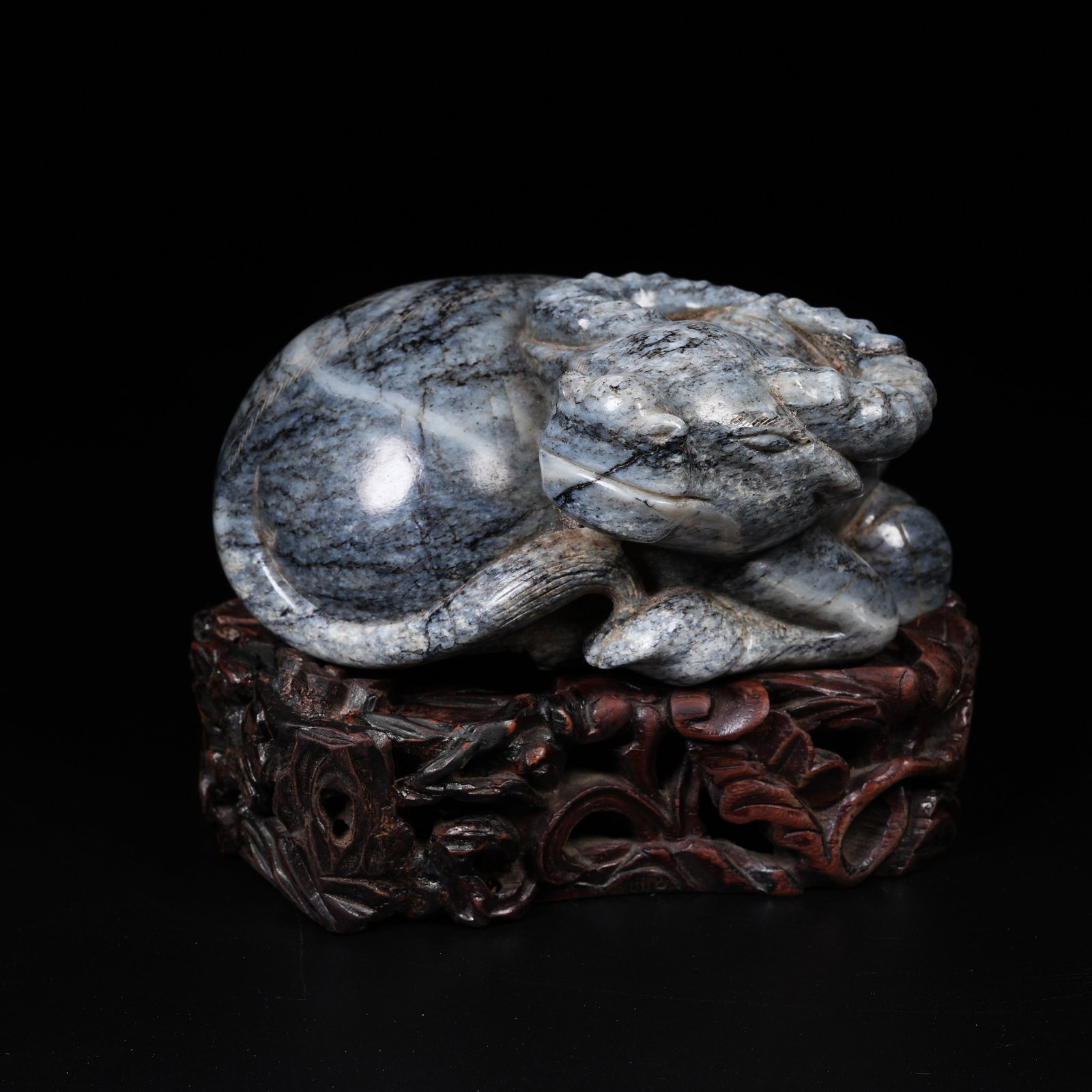 A HETIAN BLUE-AND-WHITE SEED JADE RECUMBENT OX ORNAMENT (1 of 8)