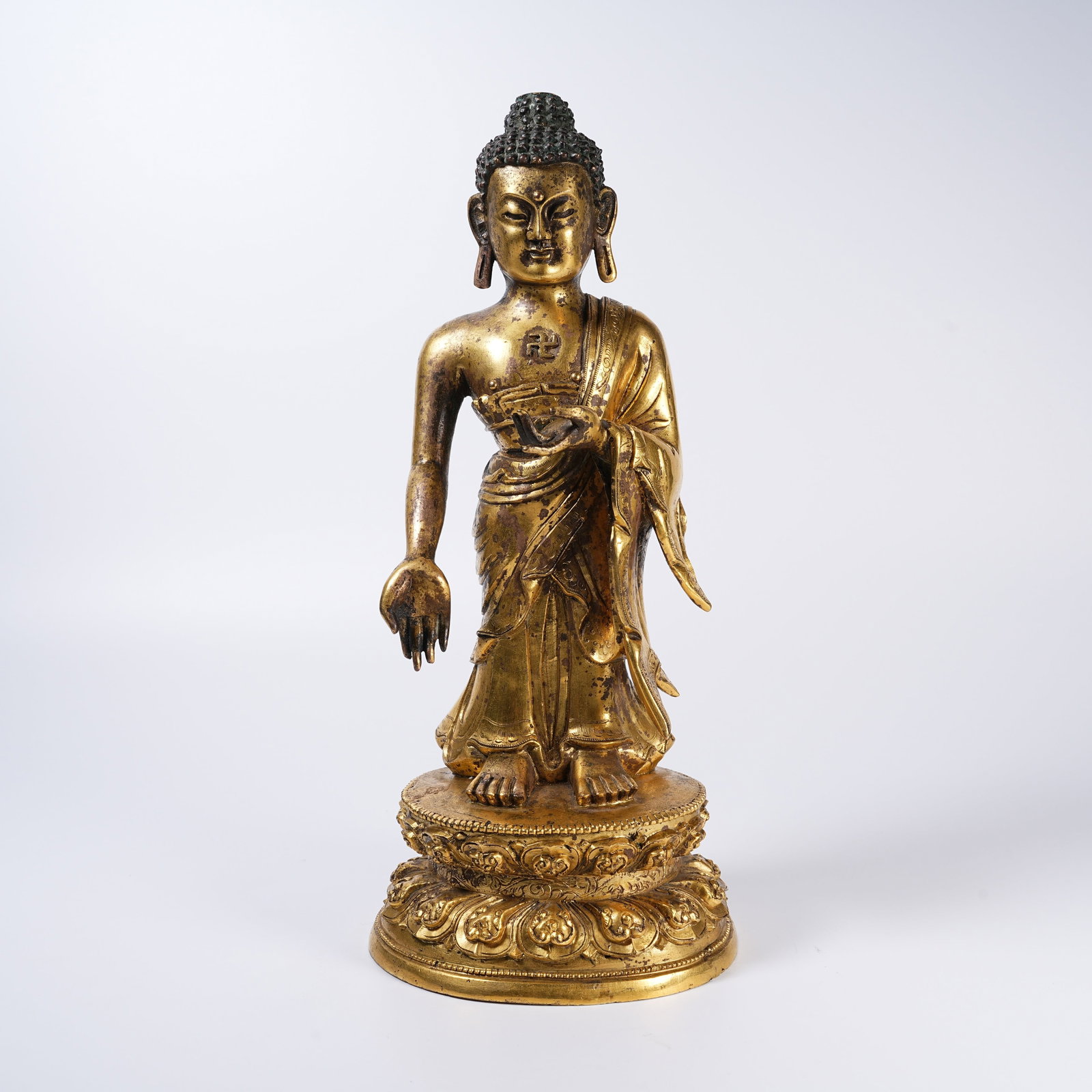 A GILT BRONZE STANDING GUIDE BUDDHA STATUE (1 of 9)