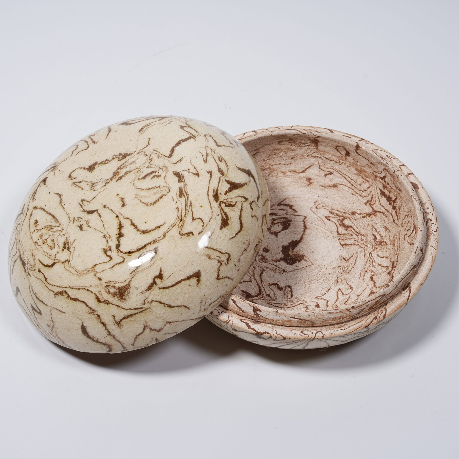 A TWISTED-BODY GLAZE COVERED BOX: Twisted-body Glaze Covered Box