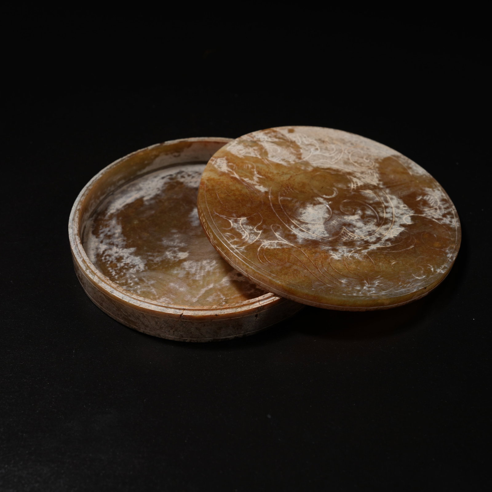 A ANCIENT JADE ROUND LIDDED BOX WITH TAIJI AND SCROLL-CLOUD MOTIF: Ancient jade round lidded box with Taiji and scroll-cloud motif