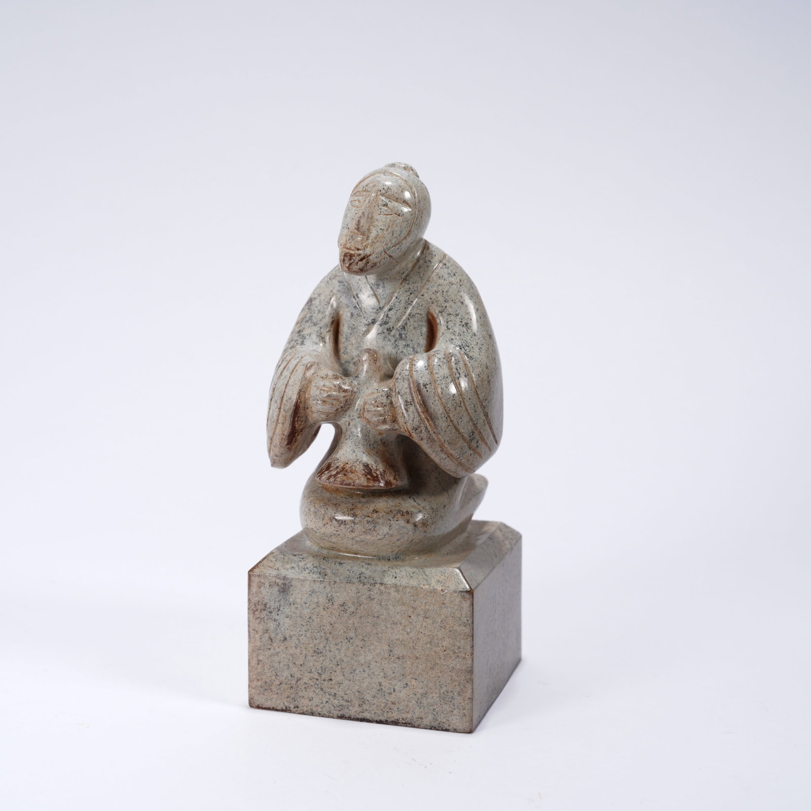 A ANCIENT JADE SEAL WITH BILI (REED PIPE) MUSICIAN FIGURE KNOB: Ancient jade seal with bili (reed pipe) musician figure knob