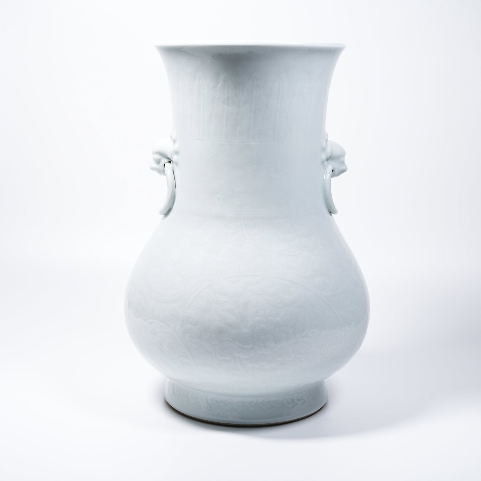 A WHITE GLAZE HIDDEN-CARVED KUI-DRAGON BEAST-HEAD ZUN VASE (1 of 9)