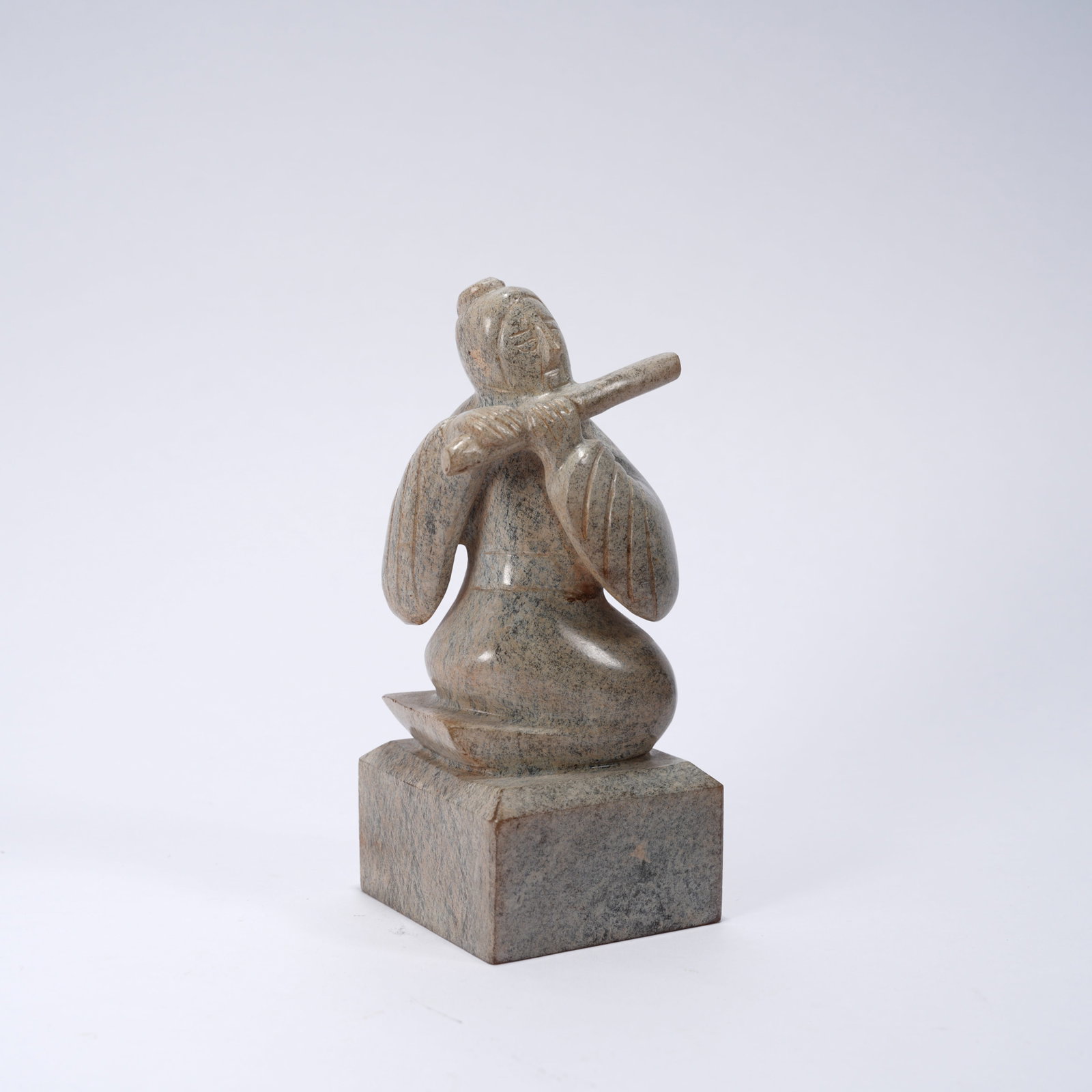 A ANCIENT JADE SEAL WITH TRANSVERSE FLUTE MUSICIAN FIGURE KNOB: Ancient jade seal with transverse flute musician figure knob