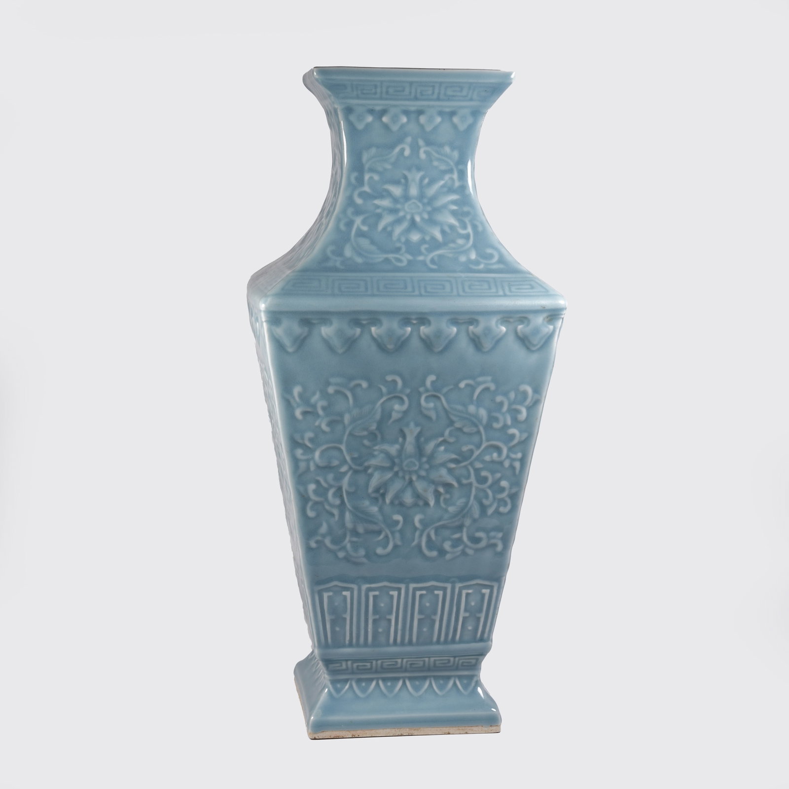 A SKY-CELADON GLAZE SQUARE ZUN VASE WITH INTERLOCKING FLORAL PATTERN: Sky-celadon Glaze Square Zun Vase with Interlocking Floral Pattern