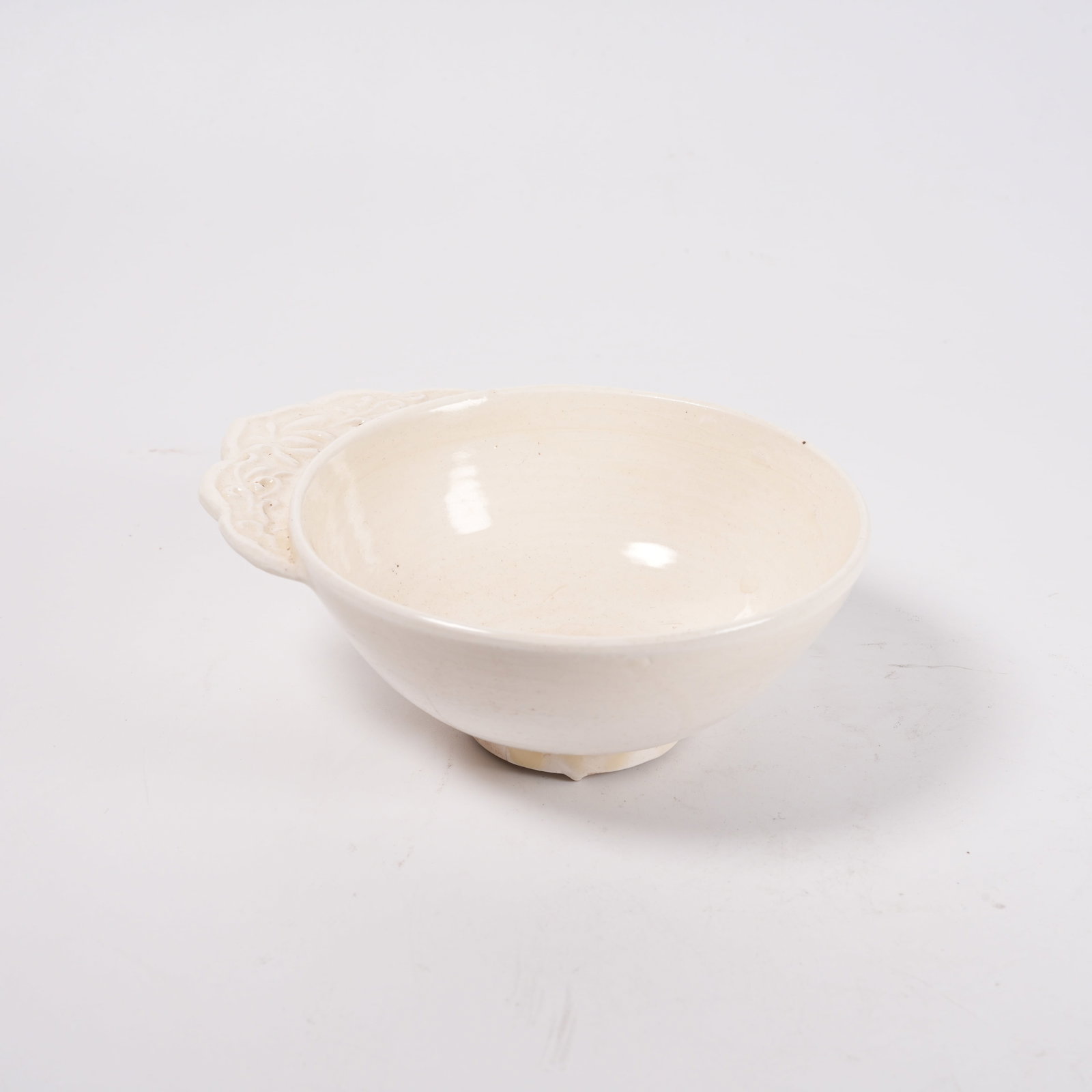 A HOZHOU KILN FLORAL EAR CUP: Hozhou Kiln Floral Ear Cup. PROVENANCE: Highlight of this sale is part of the collection of K'ung Hsiang-Hsi (Kong Xiangxi, 孔祥熙, 1880-1967). Born in Taigu, Shanxi province, to a