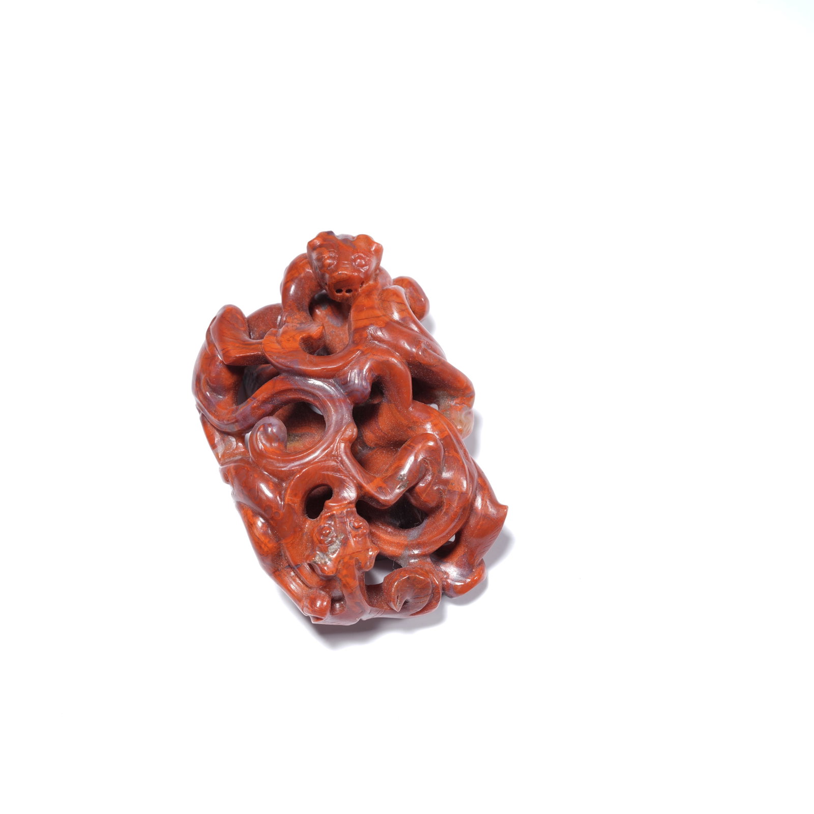 A WARRING STATES RED AGATE OPENWORK CHI-DRAGON MOTIF "CHICKEN-HEART" PENDANT: Warring States red agate openwork chi-dragon motif "chicken-heart" pendant