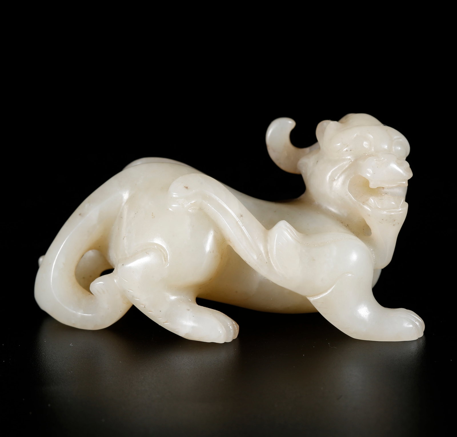 A CHIHU TIGER-SHAPED ORNAMENT CARVED FROM HETIAN JADE: Chihu Tiger-shaped Ornament Carved from Hetian Jade