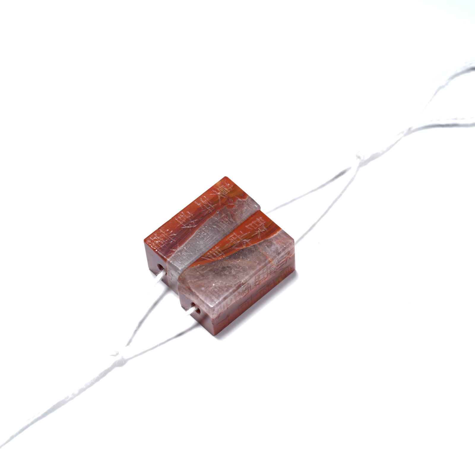 A WARRING STATES RED AGATE TWIN-CLASP ORNAMENT (1 of 6)