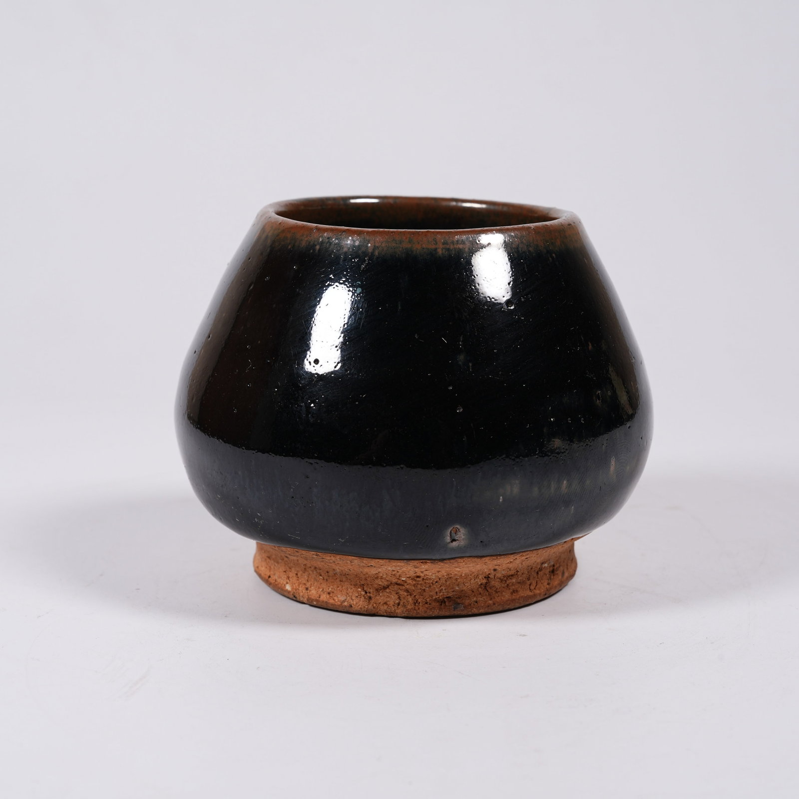A BLACK GLAZE HEART-SHAPED JAR: Black Glaze Heart-shaped Jar