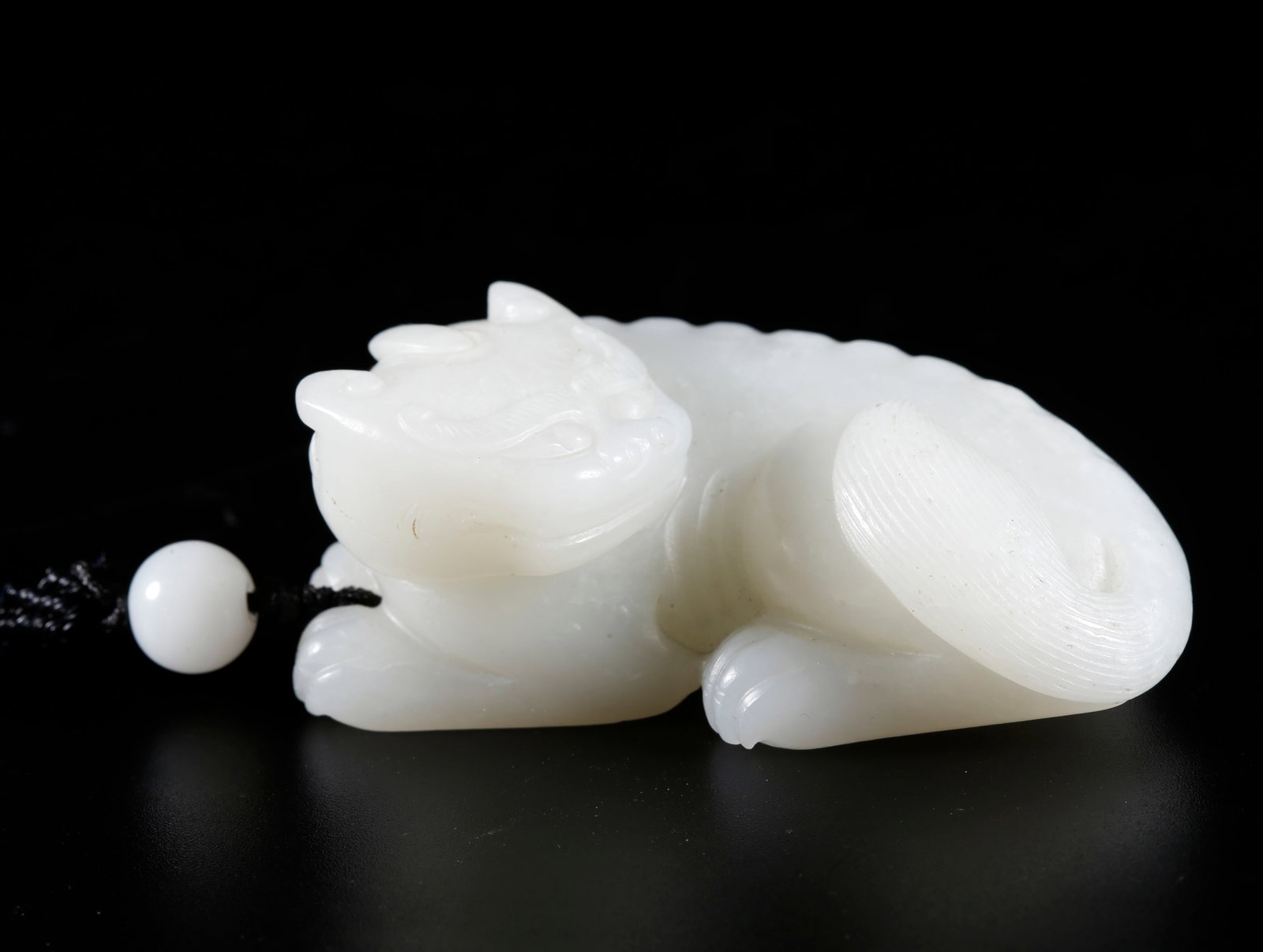 A TIGER-SHAPED HANDHELD ORNAMENT CARVED FROM HETIAN JADE (1 of 9)