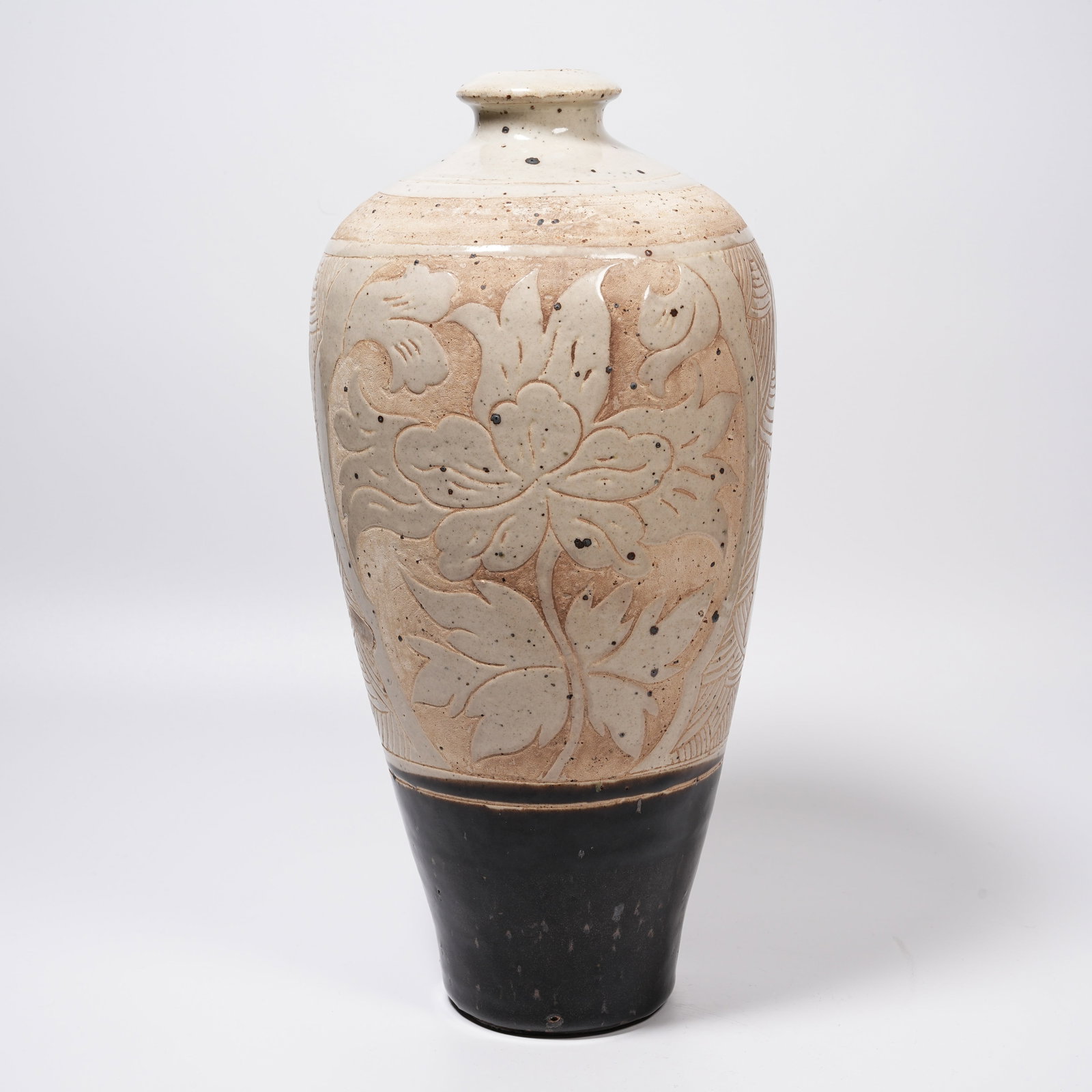 A LINGWU KILN CARVED PLUM VASE (1 of 9)