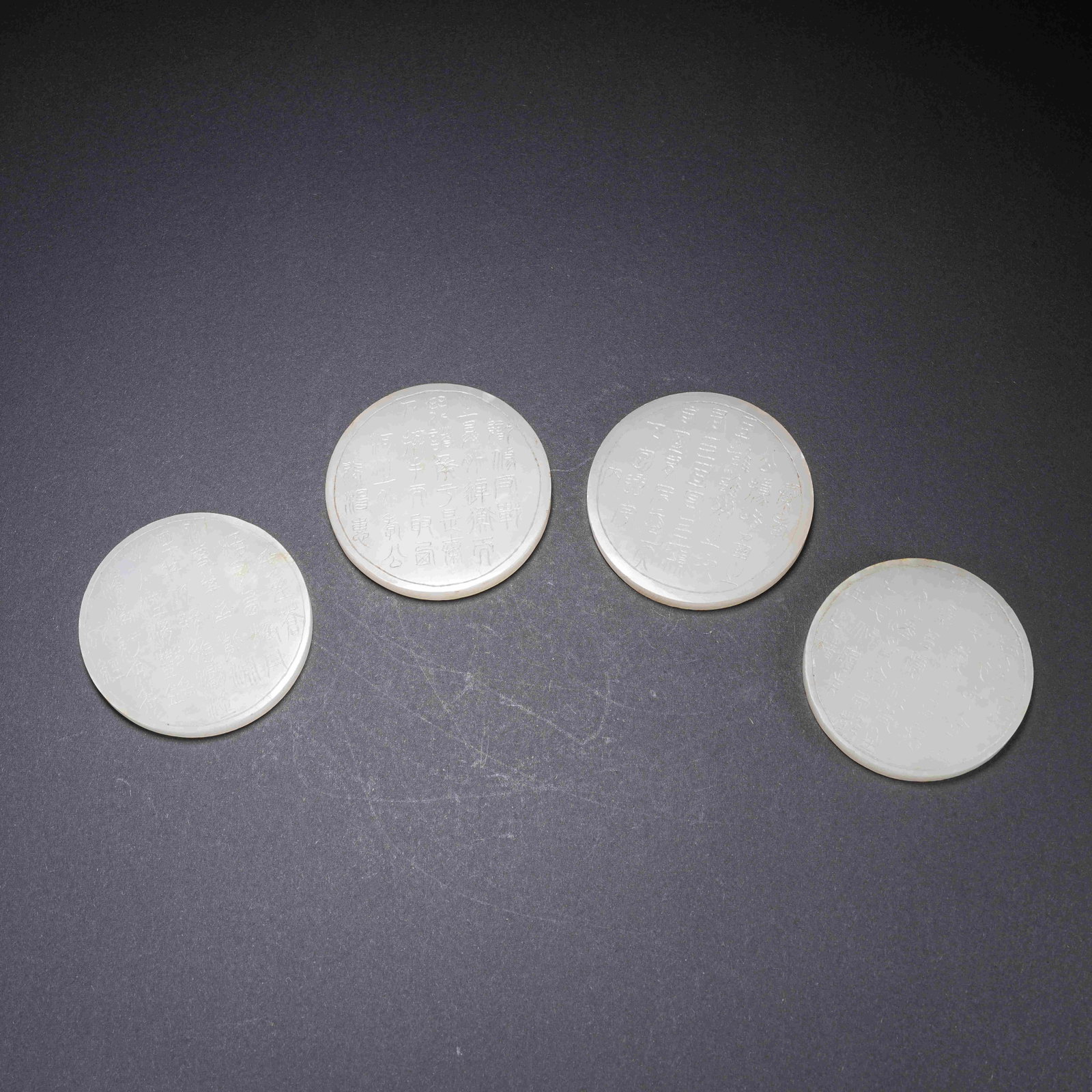 A HETIAN JADE ROUND PLAQUES WITH INSCRIBED POETRY: Hetian Jade Round Plaques with Inscribed Poetry