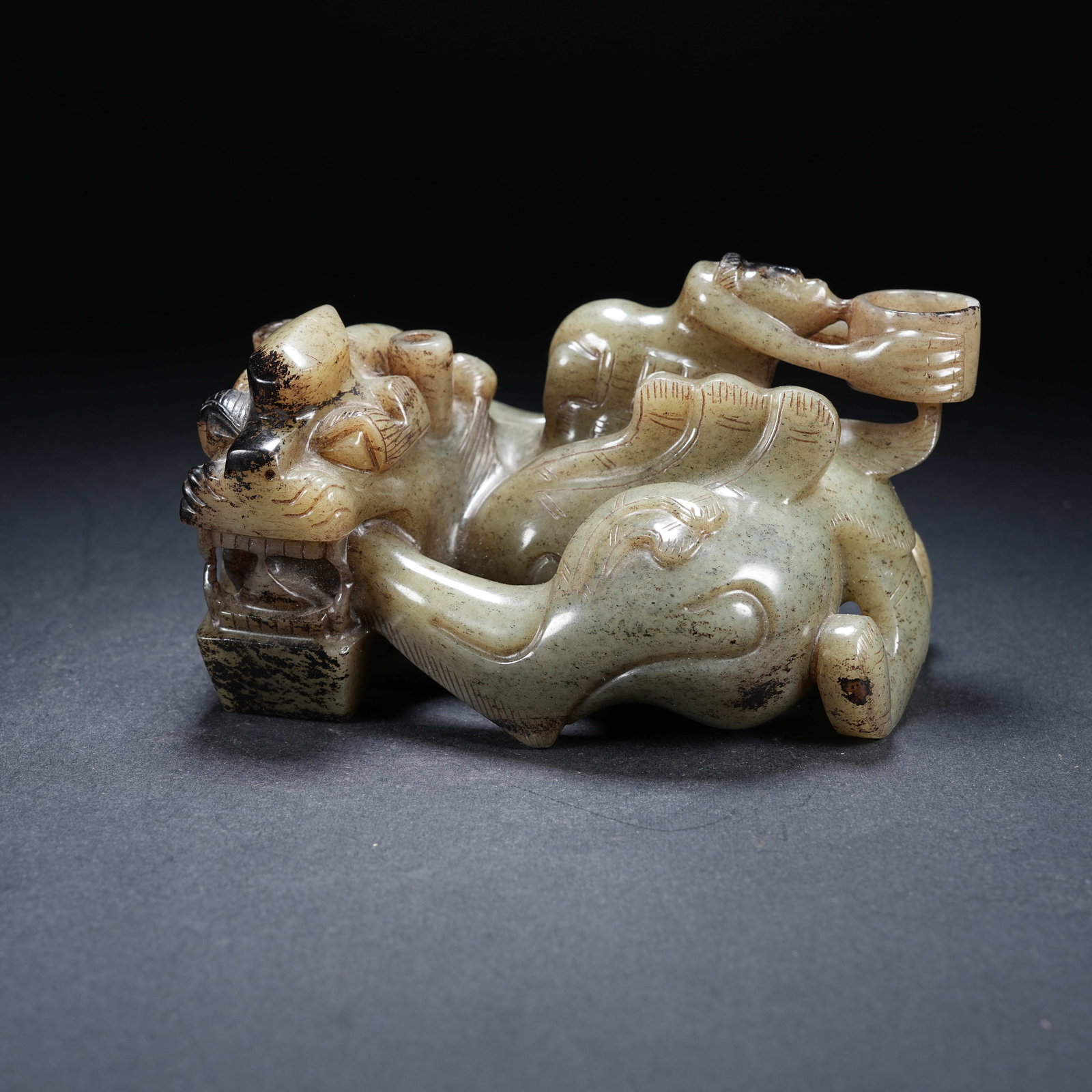 A ARCHAIC JADE INCENSE HOLDER WITH HUMAN RIDING BEAST LAMPSTAND: Archaic Jade Incense Holder with Human Riding Beast Lampstand